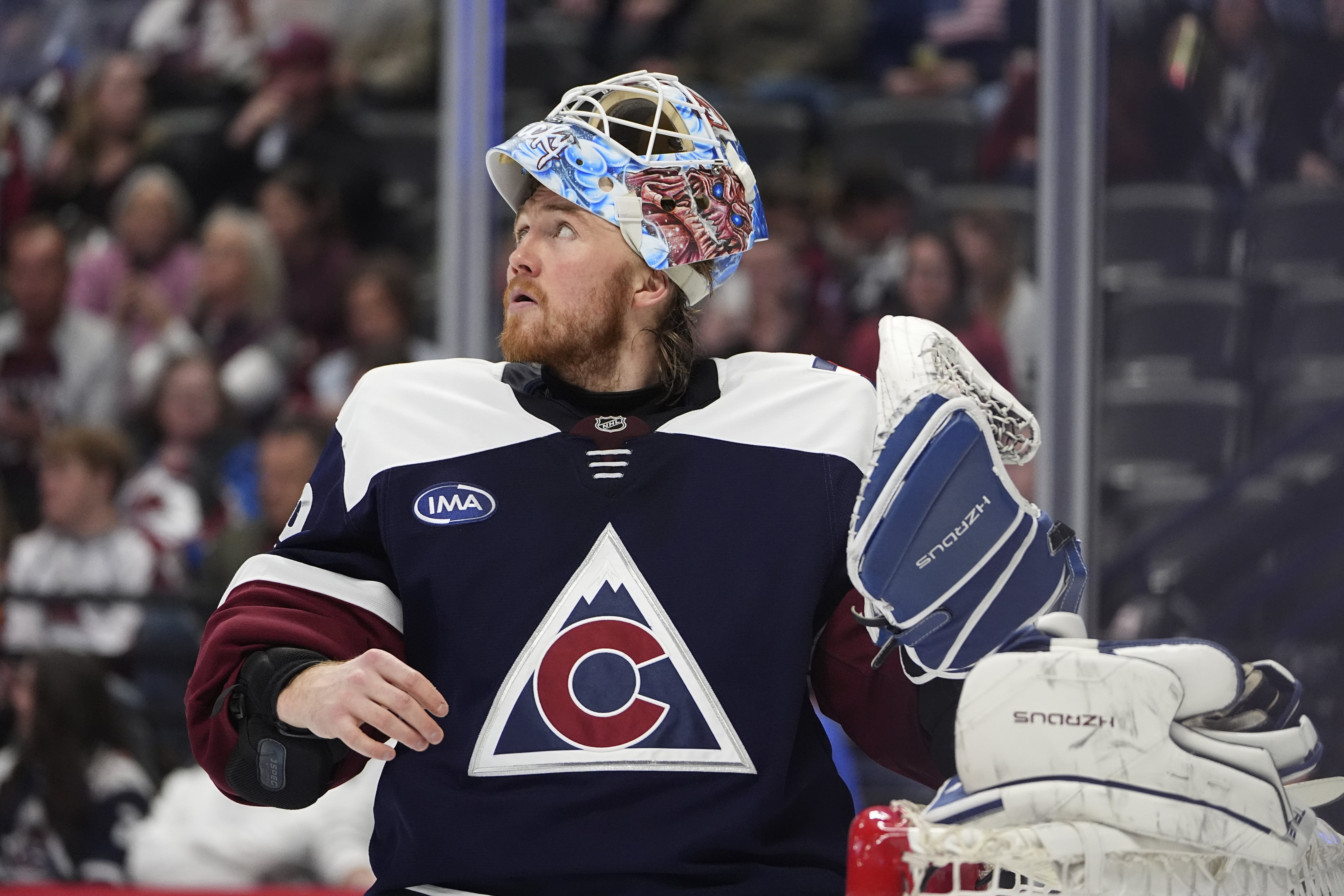 Colorado Avalanche goaltender Mackenzie Blackwood pulls on his gloves during a timeout in the second period of an NHL hockey game against the St. Louis Blues, Friday, Jan. 31, 2025, in Denver. 