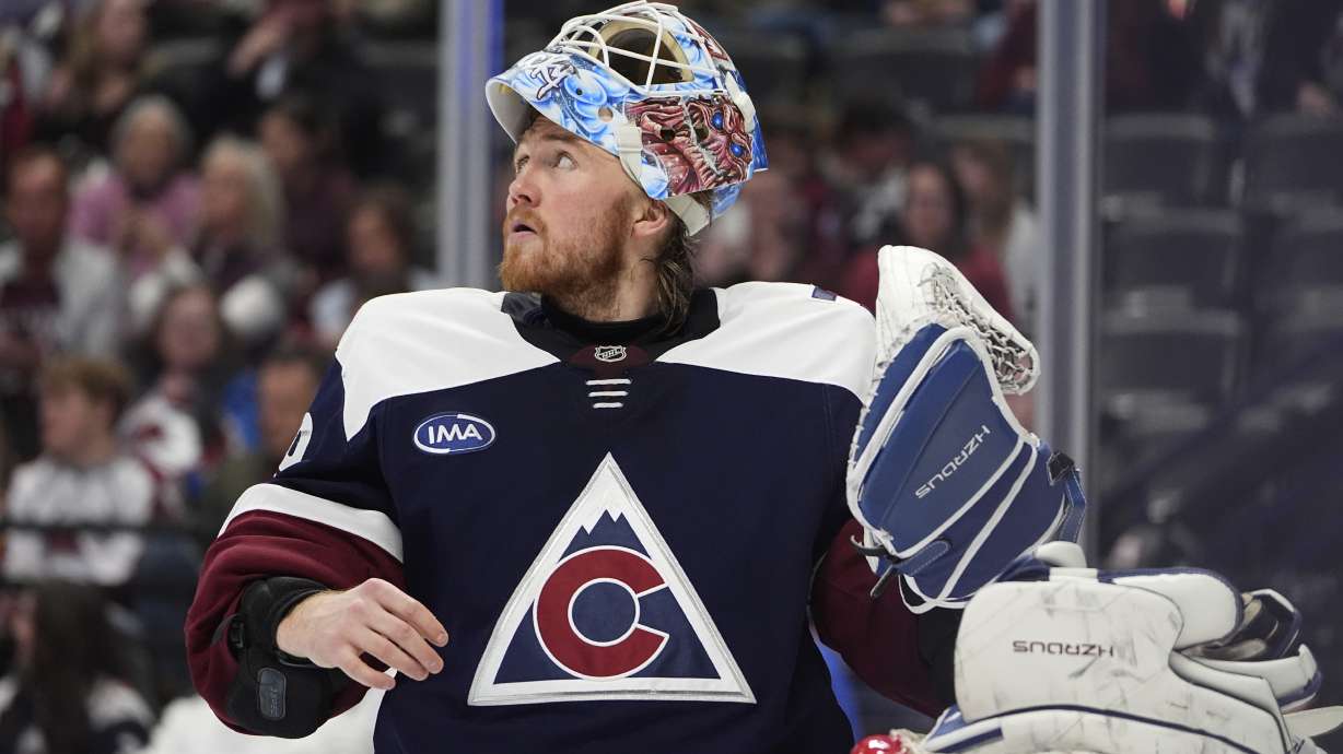 Colorado Avalanche goaltender Mackenzie Blackwood pulls on his gloves during a timeout in the second period of an NHL hockey game against the St. Louis Blues, Friday, Jan. 31, 2025, in Denver.