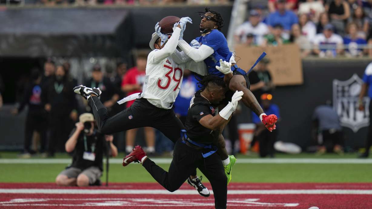 NFC wide receiver Malik Nabers, of the New York Giants, right, catches a pass while defended by AFC safety Minkah Fitzpatrick (39), of the Pittsburgh Steelers, during the flag football event at the NFL Pro Bowl, Sunday, Feb. 2, 2025, in Orlando.