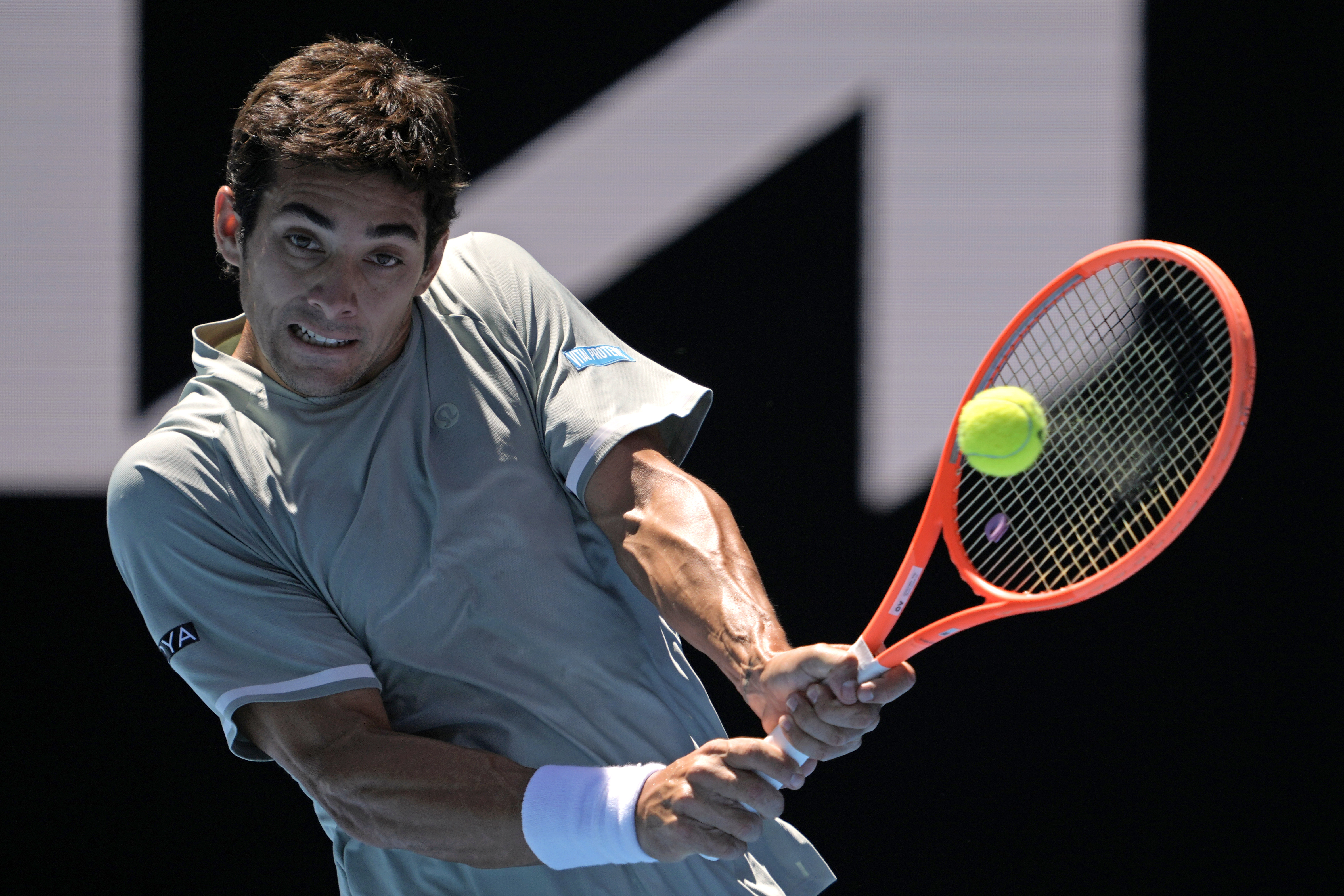 Cristian Garin of Chile plays a backhand return to Taylor Fritz of the U.S. during their second round match at the Australian Open tennis championship in Melbourne, Australia, Thursday, Jan. 16, 2025.