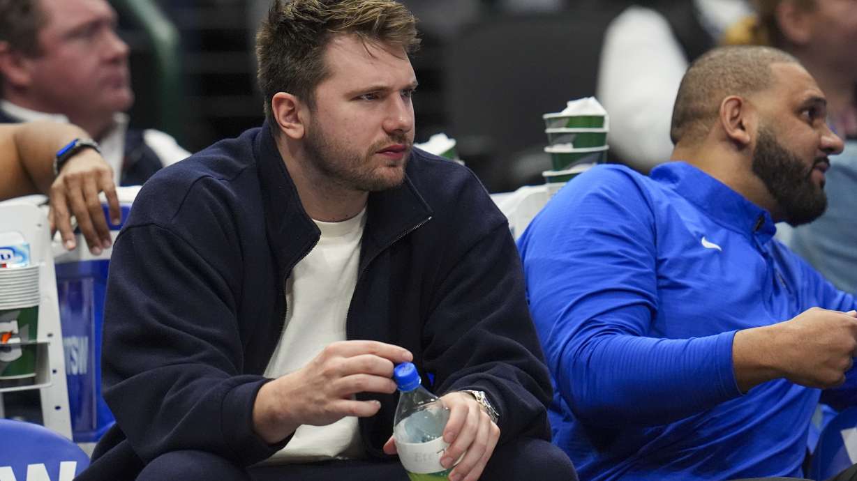 Dallas Mavericks guard Luka Doncic looks on from the bench during the second half of an NBA basketball game against the Denver Nuggets, Sunday, Jan. 12, 2025, in Dallas. The Nuggets won 112-101.