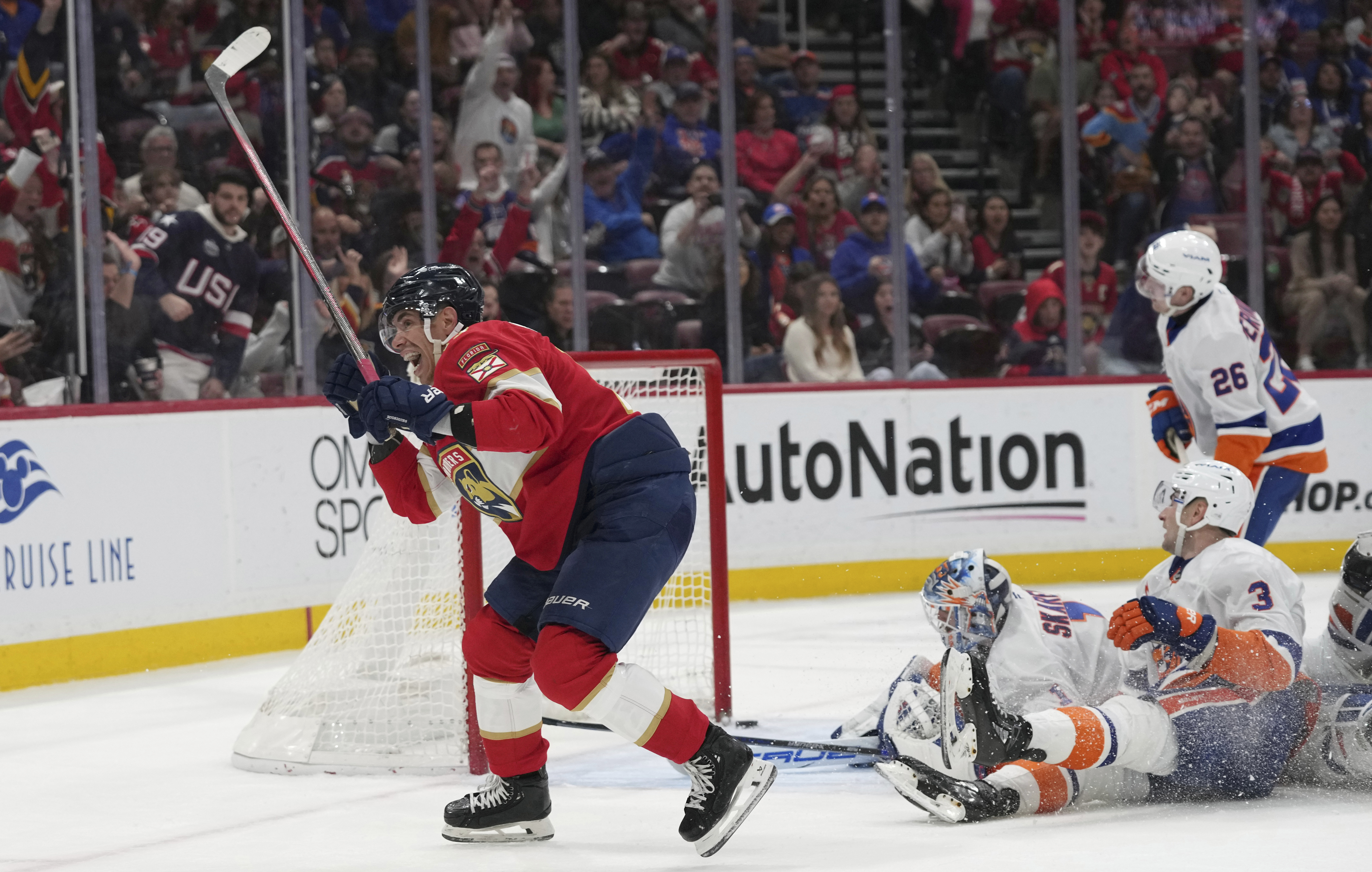 Florida Panthers center Evan Rodrigues, left, reacts after scoring against New York Islanders goalie Jakub Skarek (1) during the second period of an NHL hockey game, Sunday, Feb. 2, 2025, in Sunrise, Fla. 