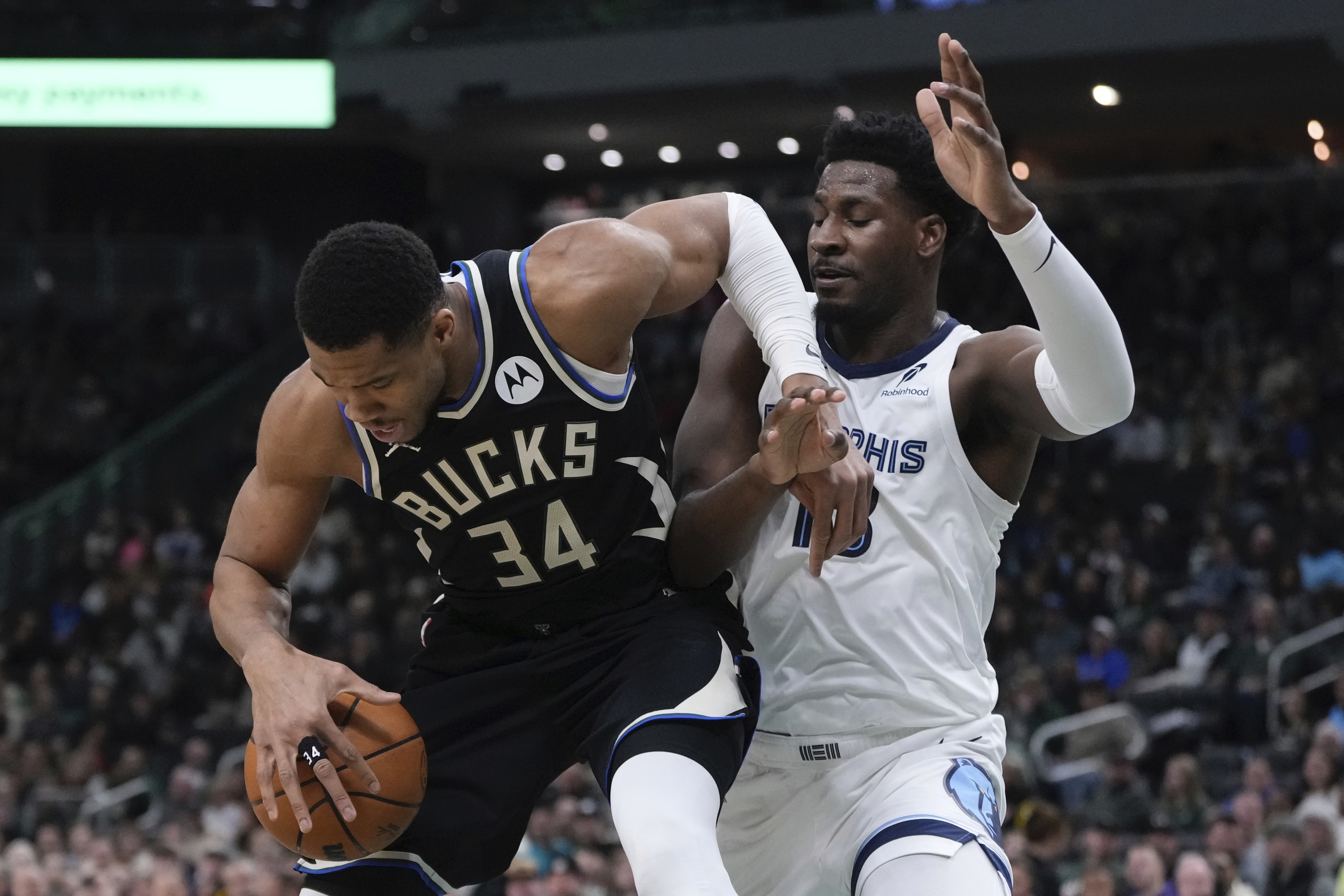 Milwaukee Bucks' Giannis Antetokounmpo tries to get past Memphis Grizzlies' Jaren Jackson Jr. during the first half of an NBA basketball game Sunday, Feb. 2, 2025, in Milwaukee.