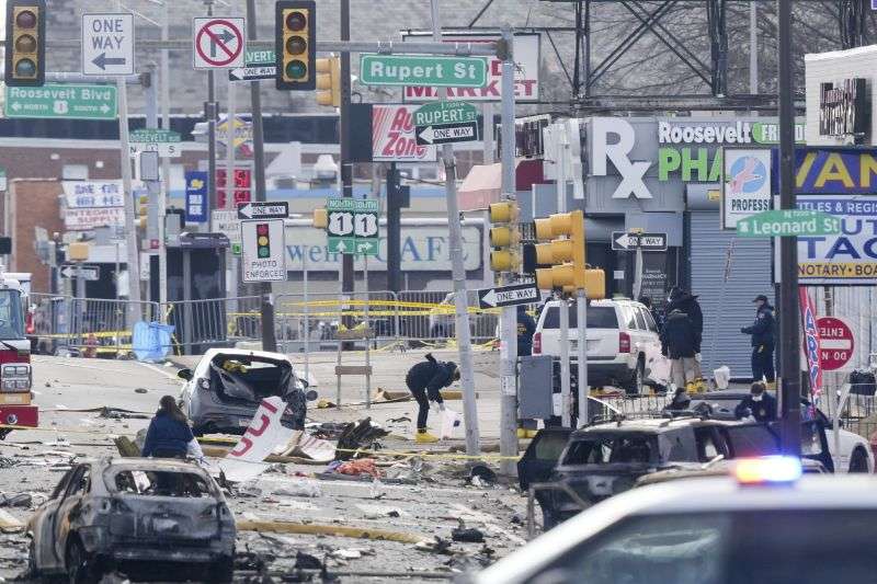 Investigators work the scene after a small plane crashed in Philadelphia, Saturday.
