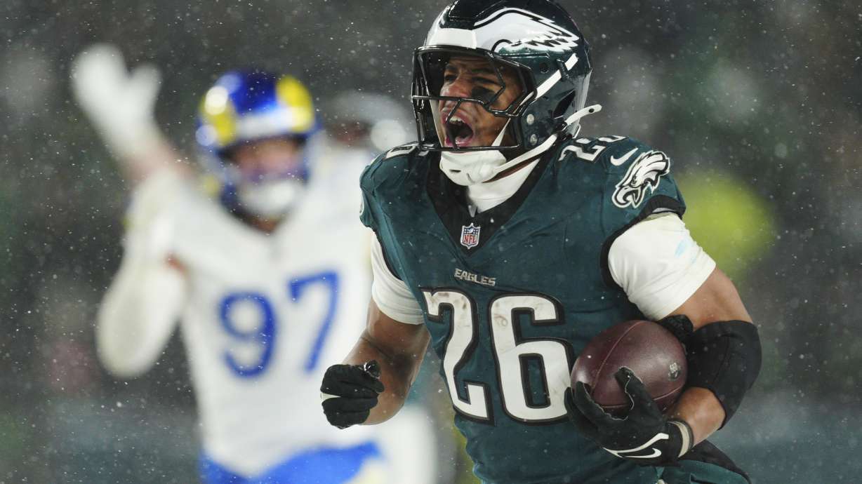 Philadelphia Eagles running back Saquon Barkley (26) runs the ball for a touchdown during the second half of an NFL football NFC divisional playoff game against the Los Angeles Rams on Sunday, Jan. 19, 2025, in Philadelphia.