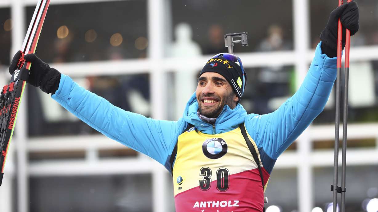 FILE - France's Martin Fourcade celebrates during the podium ceremony after winning the men's 20km individual competition at the Biathlon World Championships in Antholz, Italy, on Feb. 19, 2020.