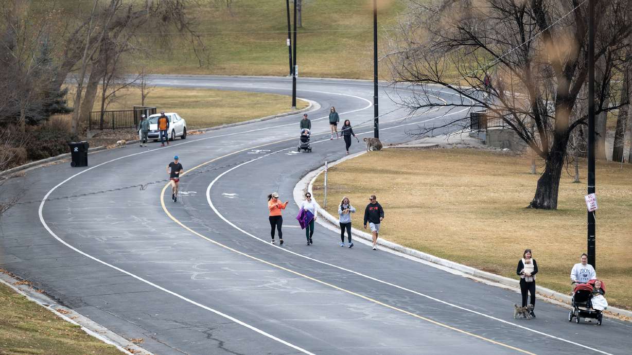 People walk at Sugar House Park in Salt Lake City on Jan. 3. Salt Lake City is one of a few cities that broke a high-temperature record on Sunday, but more record-warm temperatures are forecast across Utah to start this week.