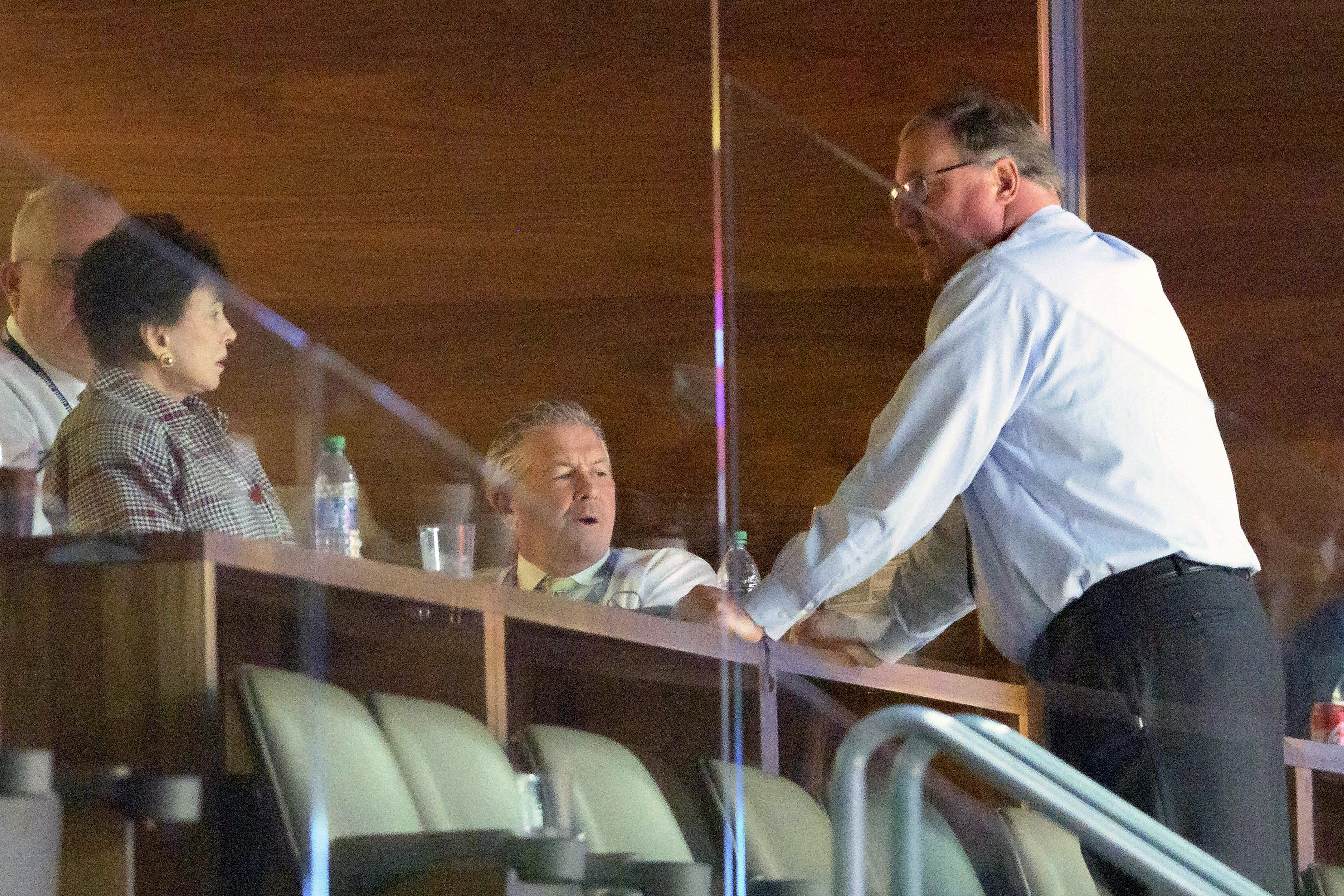 FILE - New Orleans Saints and Pelicans owner Gayle Benson, left, talks with Saints President Dennis Lauscha, right, next to VP Greg Bensel, center, in the second half of an NBA basketball game against the Los Angeles Clippers in New Orleans, Sunday, March 14, 2021. 