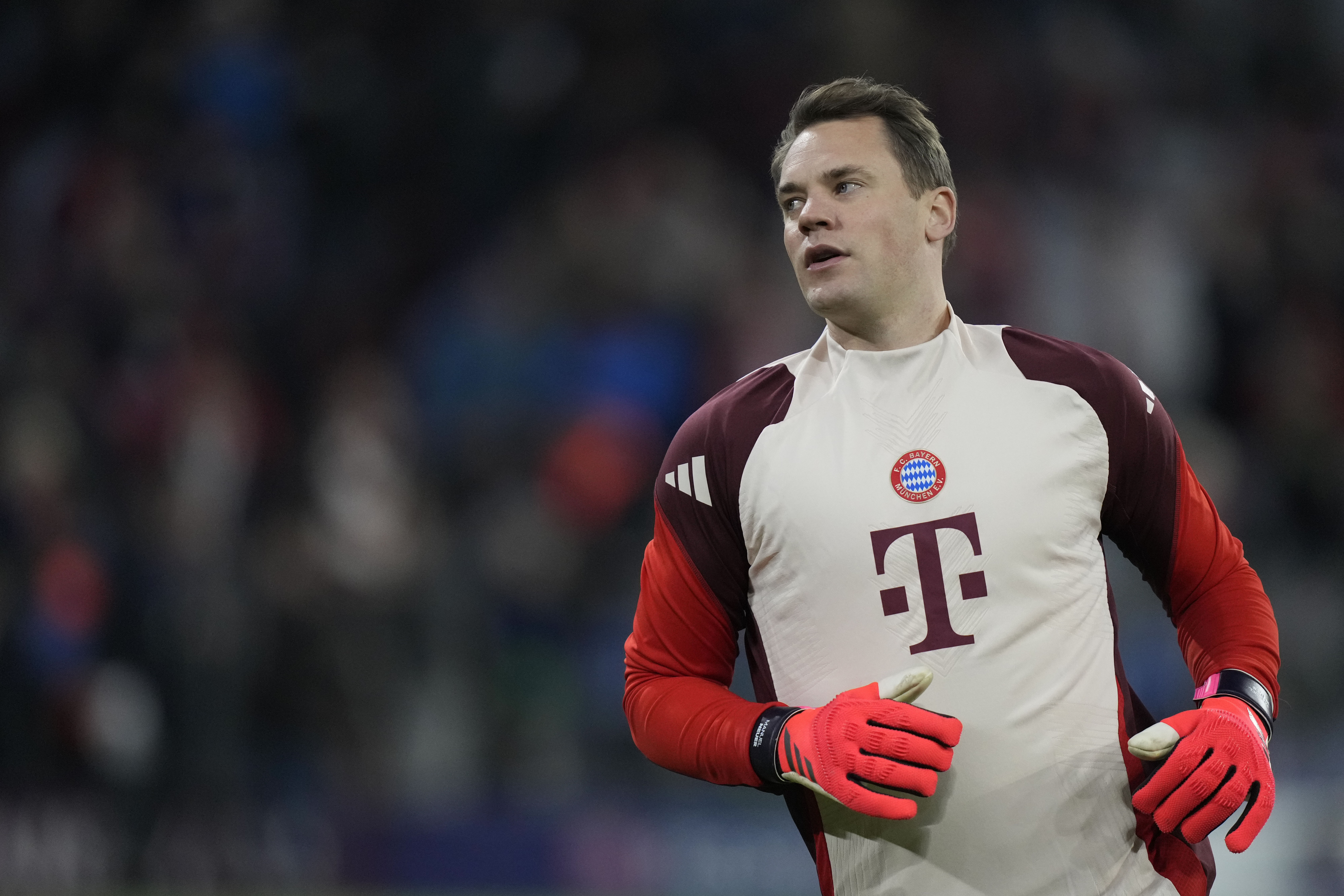 FILE - Bayern's goalkeeper Manuel Neuer stretches himself during warm up before the Champions League opening phase soccer match between FC Bayern and Paris Saint Germain, at the Allianz Arena in Munich, Germany, Tuesday, Nov. 26, 2024. 