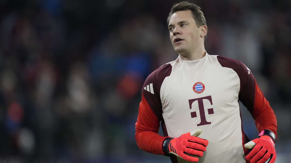 FILE - Bayern's goalkeeper Manuel Neuer stretches himself during warm up before the Champions League opening phase soccer match between FC Bayern and Paris Saint Germain, at the Allianz Arena in Munich, Germany, Tuesday, Nov. 26, 2024.