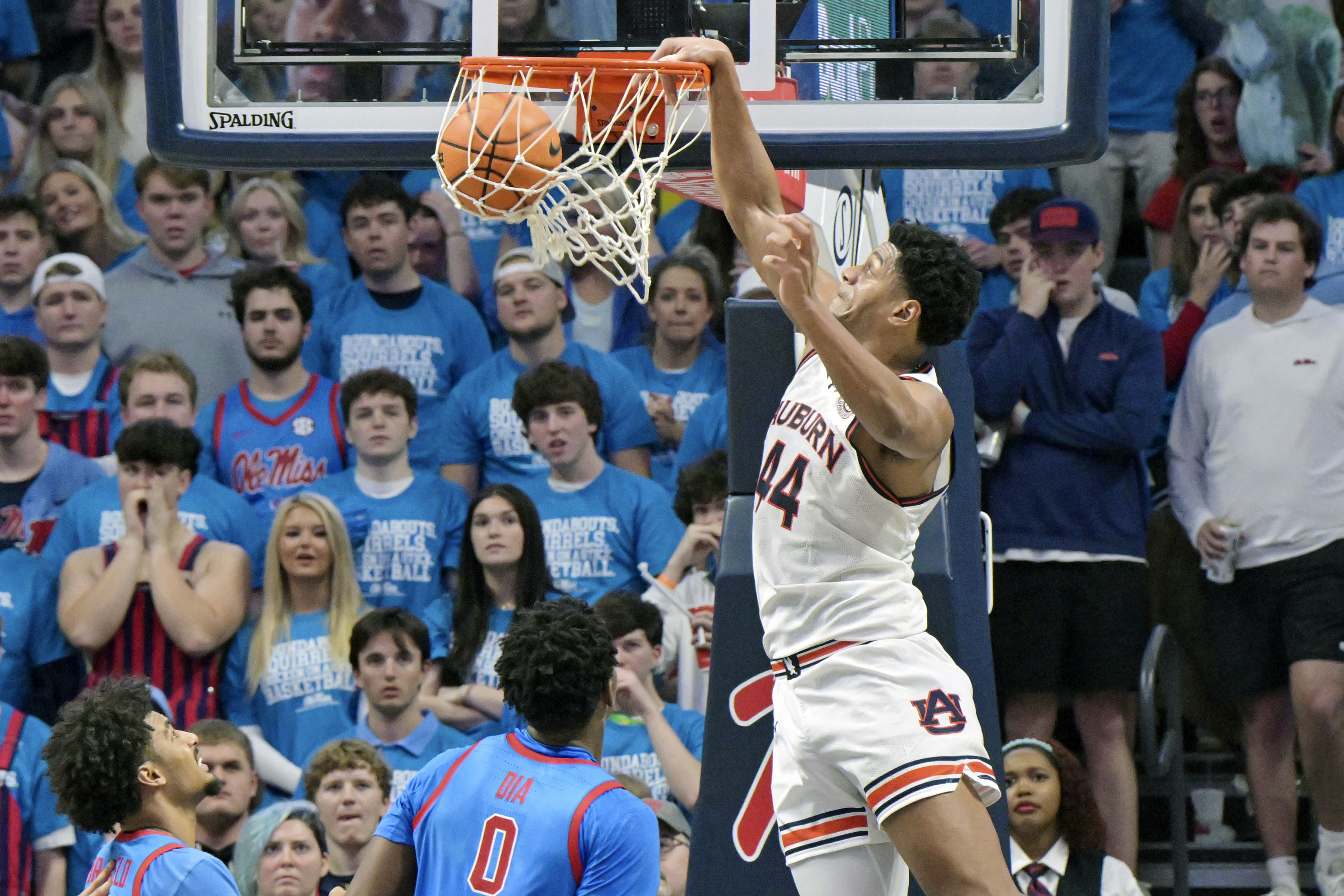 Auburn center Dylan Cardwell (44) dunks against Mississippi forward Jaemyn Brakefield (4), left, and Mississippi forward Malik Dia (0) during the second half of an NCAA college basketball game in Oxford, Miss., Saturday, Feb. 1, 2025. 