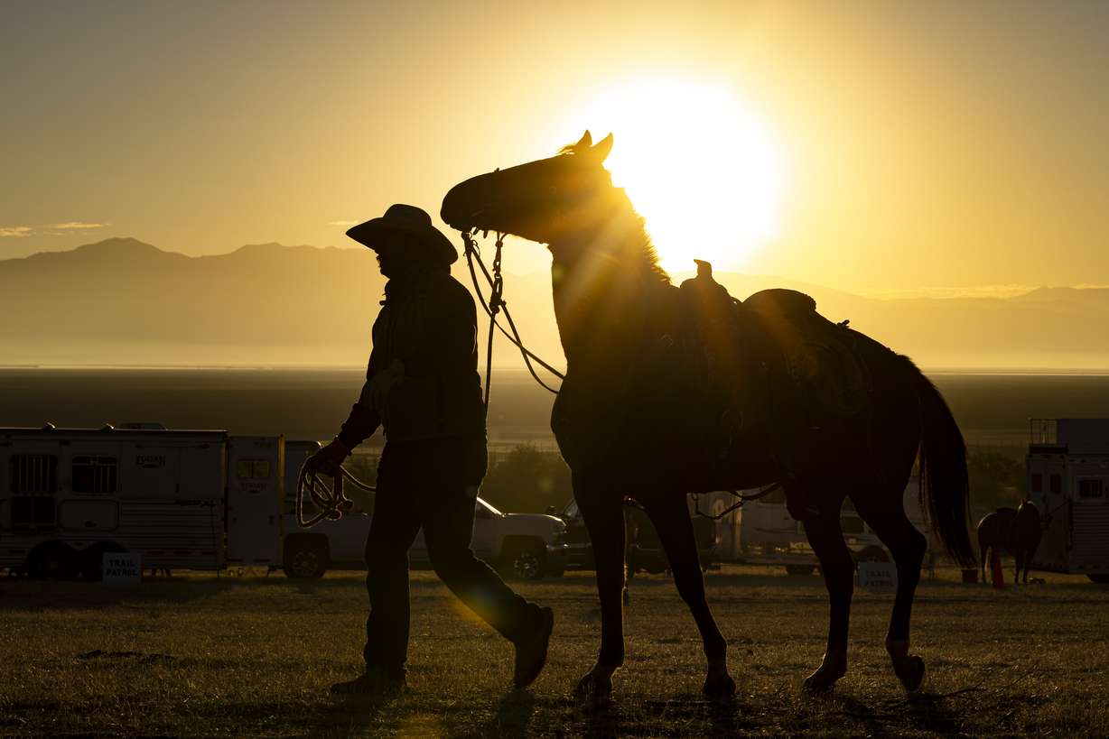 A rider walks with their horse before the 36th annual Bison Roundup, held at Antelope Island State Park, southwest of Syracuse, on Oct. 26, 2024.