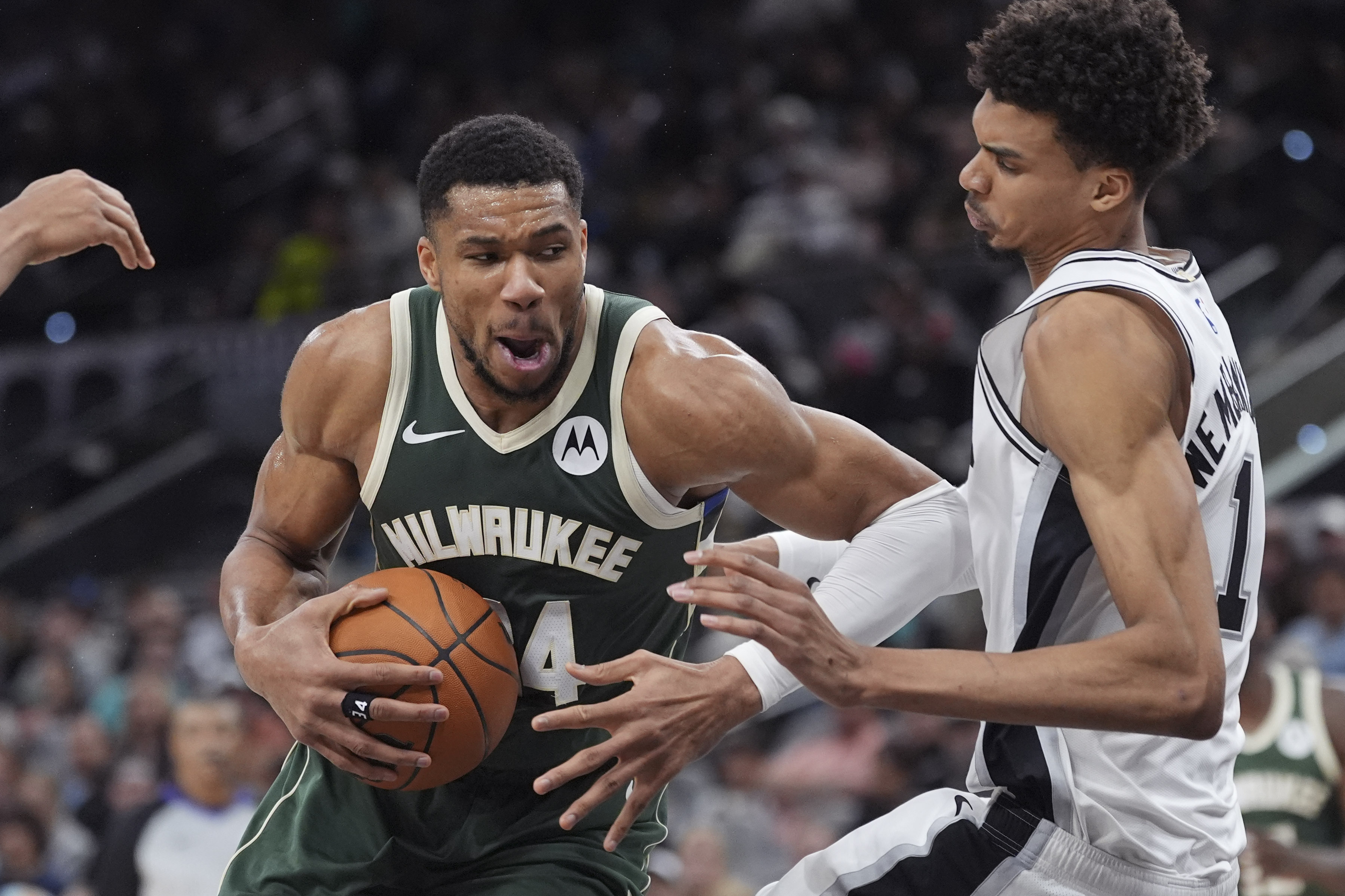 Milwaukee Bucks forward Giannis Antetokounmpo, left, drives against San Antonio Spurs center Victor Wembanyama (1) during the first half of an NBA basketball game in San Antonio, Friday, Jan. 31, 2025. 
