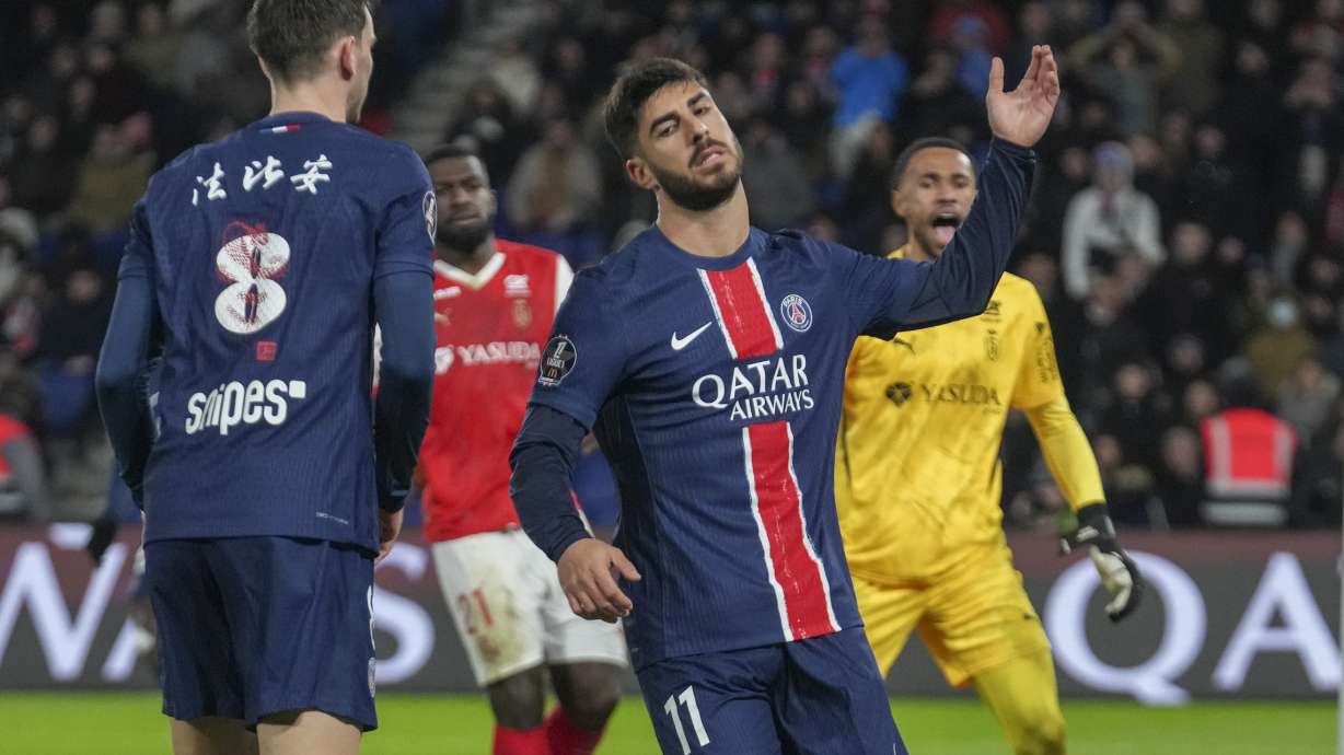 PSG's Marco Asensio, centre, reacts after missing a chance during the French League One soccer match between Paris Saint-Germain and Reims at Parc des Princes stadium in Paris, Saturday, Jan. 25, 2025.