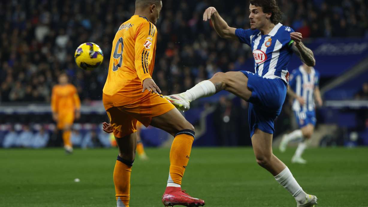 Espanyol's Carlos Romero, right, challenges for the ball with Real Madrid's Kylian Mbappe during a Spanish La Liga soccer match between Espanyol and Real Madrid at the Lluis Companys Olympic Stadium in Barcelona, Spain, Saturday Feb.1, 2025.