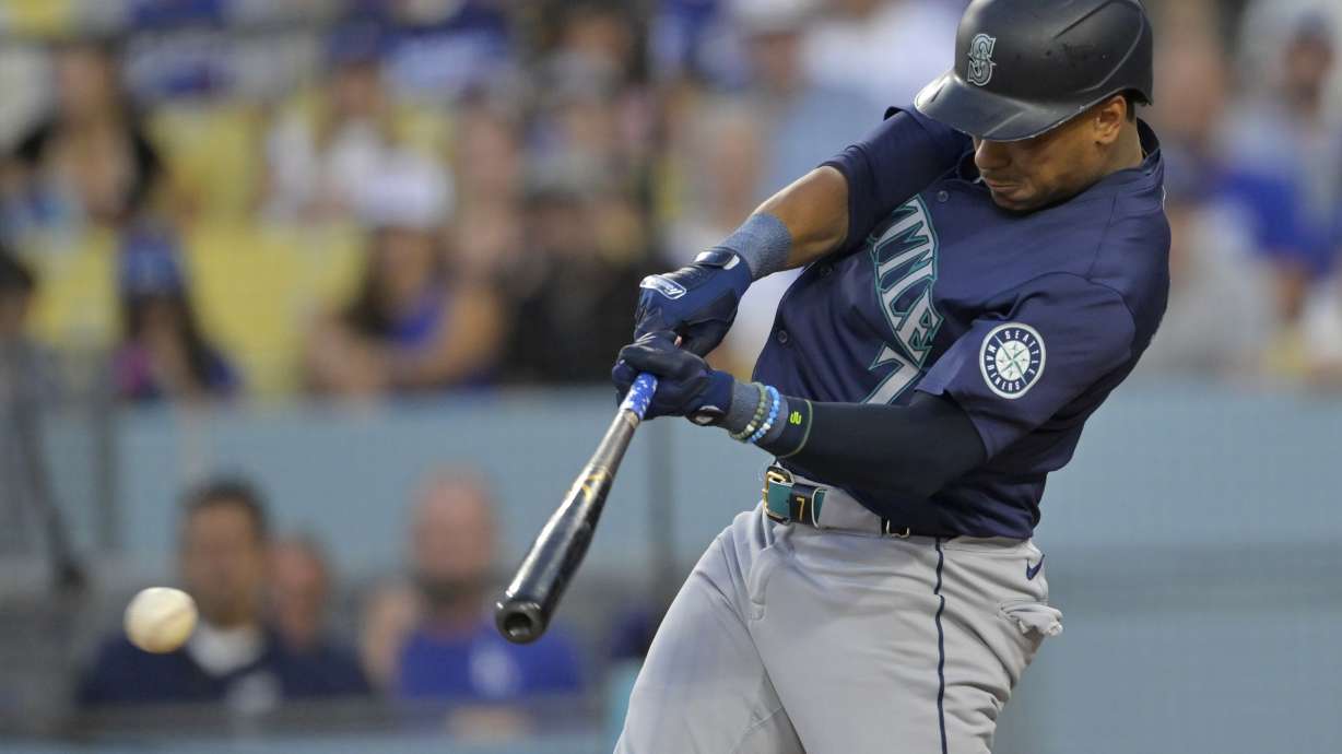 FILE - Seattle Mariners' Jorge Polanco singles in two runs during the first inning of a baseball game against the Los Angeles Dodgers, Aug. 20, 2024, in Los Angeles.