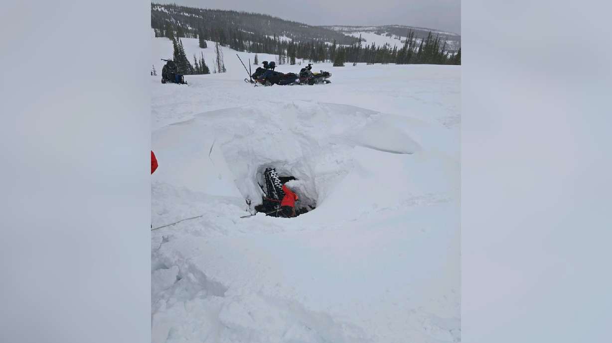 A search and rescue team rescues a snowmobiler after the snowmobiler crashed into a vertical mine shaft at Soapstone Basin on Sunday.
