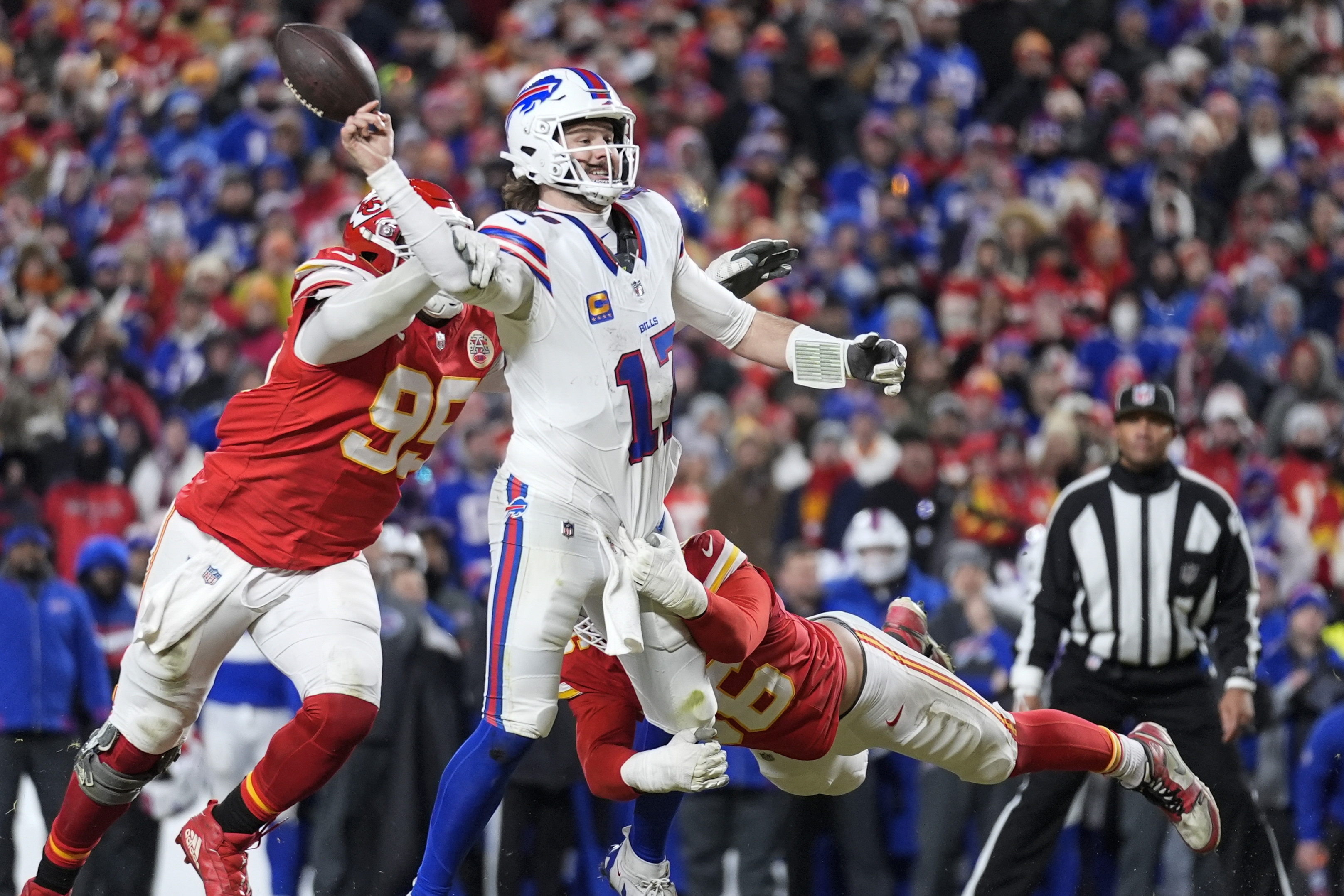 Kansas City Chiefs defensive tackle Chris Jones (95) hits Buffalo Bills quarterback Josh Allen (17) causing a fumble during the second half of the AFC Championship NFL football game, Sunday, Jan. 26, 2025, in Kansas City, Mo.