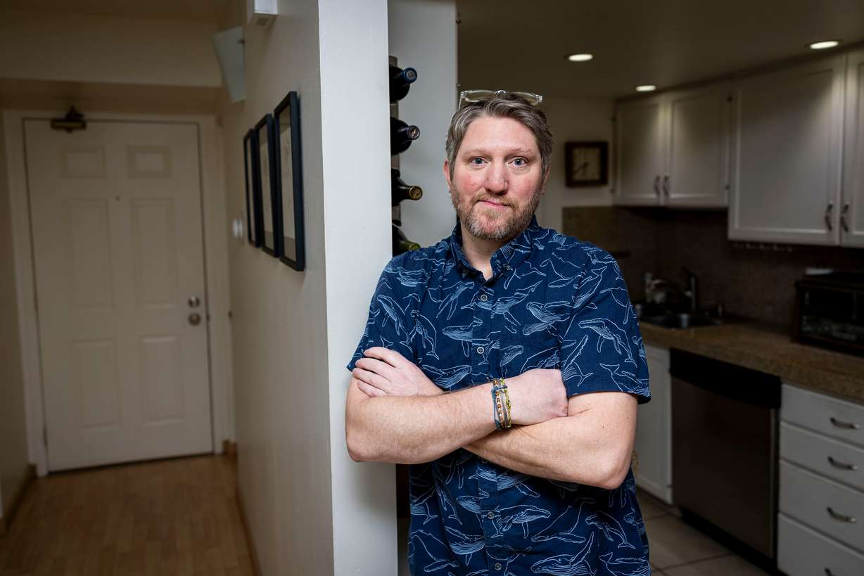 Lon Galloway poses for a portrait at his condo in Salt Lake City on Jan. 31. A dispute between Galloway and his HOA began in 2018 when a $50 fine eventually ballooned over the years to roughly $30,000 owed in fees and fines.