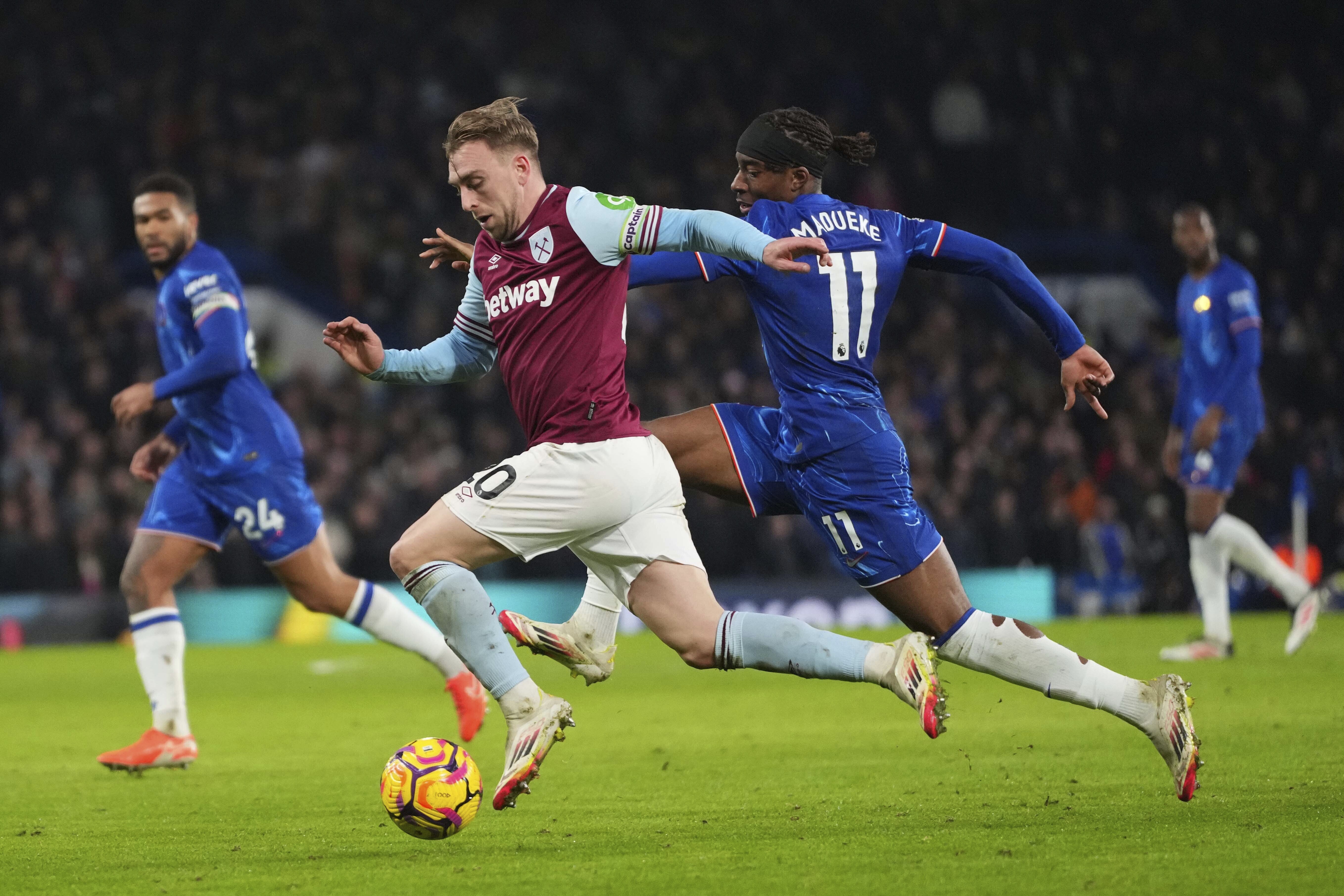 West Ham's Jarrod Bowen, foreground, and Chelsea's Noni Madueke challenge for the ball during the English Premier League soccer match between Chelsea and West Ham United at Stamford Bridge stadium in London, Monday, Feb. 3, 2025. 