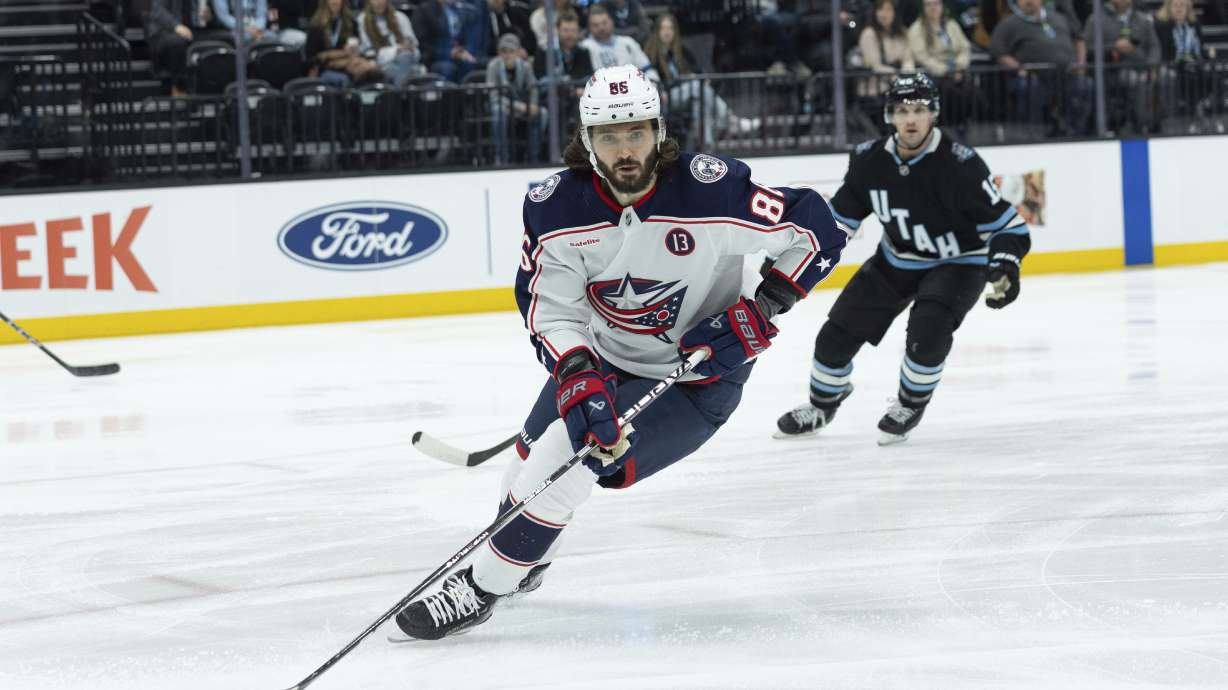 Columbus Blue Jackets right wing Kirill Marchenko (86) skates with the puck against Utah Hockey Club center Alexander Kerfoot (15) during the first period of an NHL hockey game Friday, Jan. 31, 2025, in Salt Lake City.