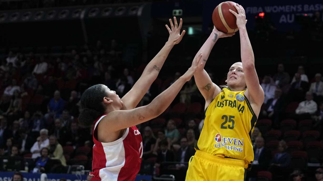 FILE - Australia's Lauren Jackson shoots over Canada's Natalie Achonwa during the bronze medal game at the women's Basketball World Cup in Sydney on Oct. 1, 2022.