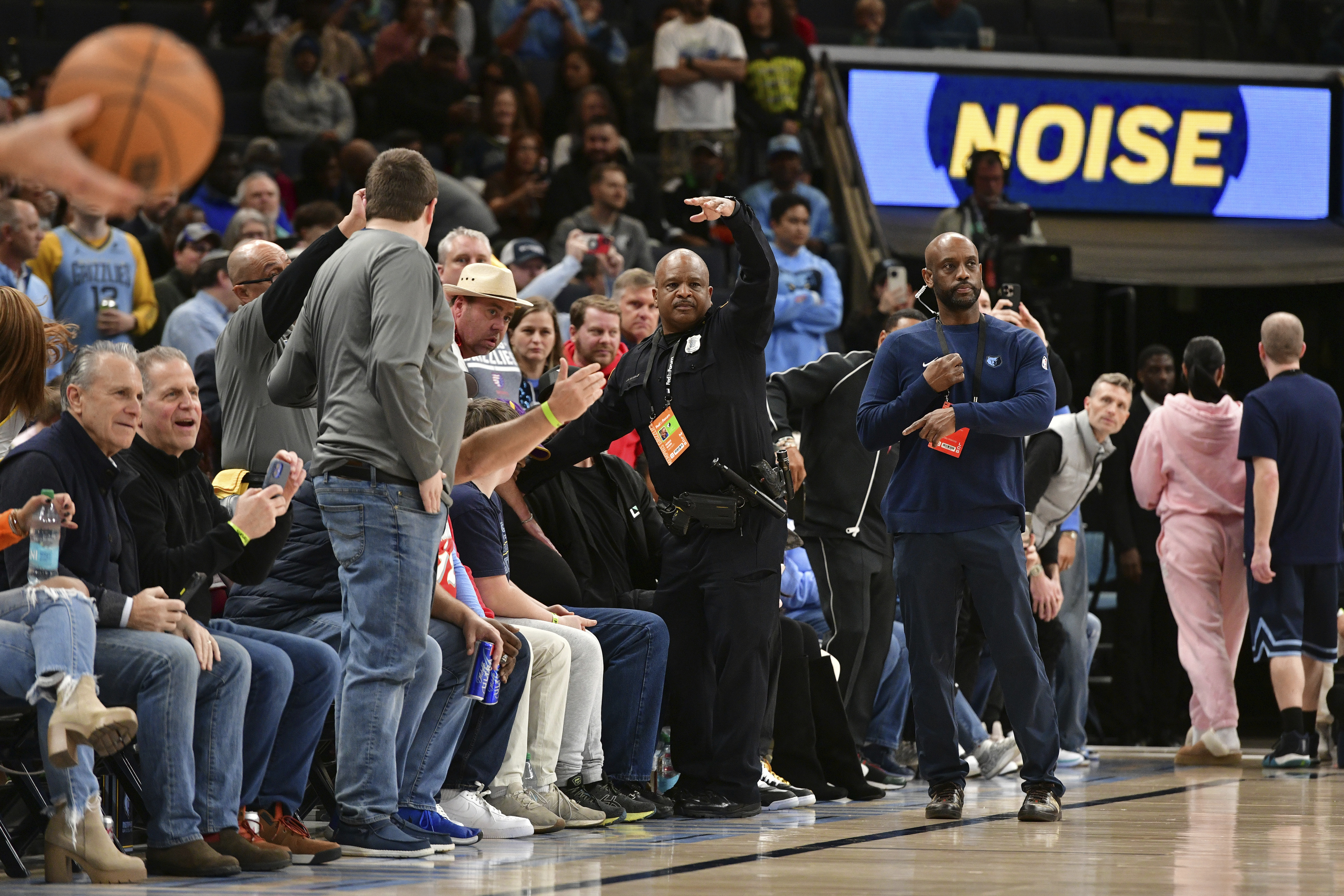 A police officer motions for help as a man has a medical emergency before an NBA basketball game between the San Antonio Spurs and the Memphis Grizzlies Monday, Feb. 3, 2025, in Memphis, Tenn. 