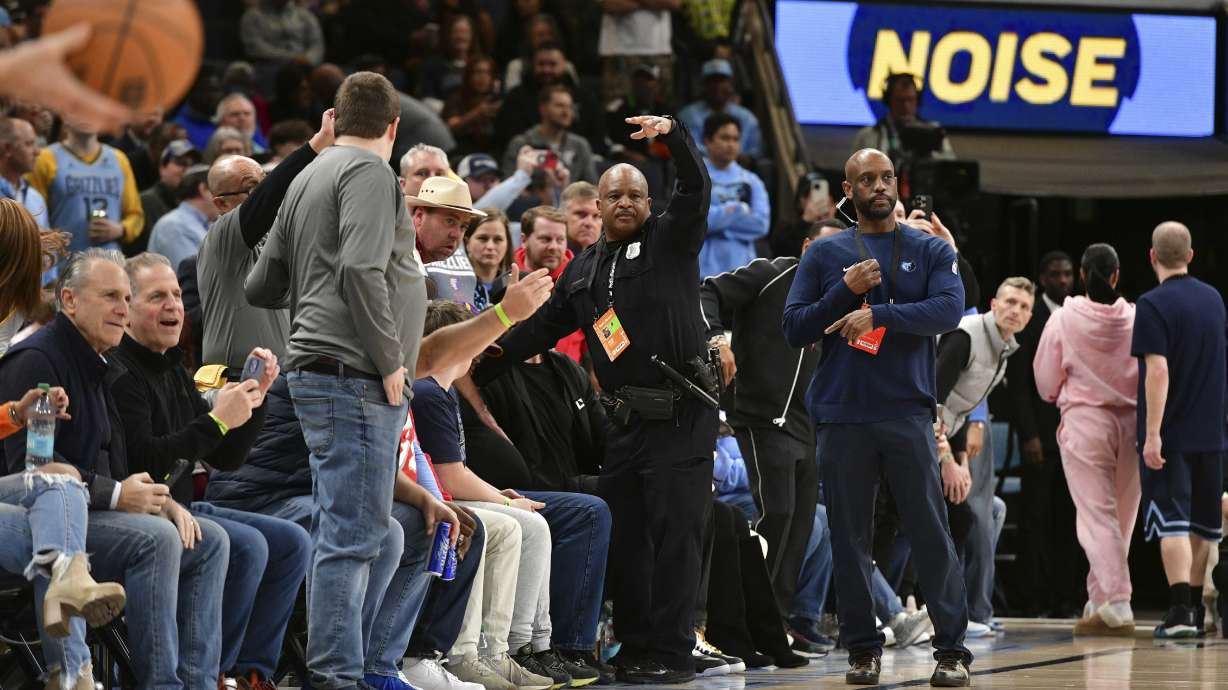 A police officer motions for help as a man has a medical emergency before an NBA basketball game between the San Antonio Spurs and the Memphis Grizzlies Monday, Feb. 3, 2025, in Memphis, Tenn.
