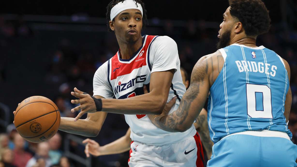 Washington Wizards guard Bilal Coulibaly, left, looks to pass the ball around Charlotte Hornets forward Miles Bridges (0) during the second half of an NBA basketball game in Charlotte, N.C., Monday, Feb. 3, 2025.