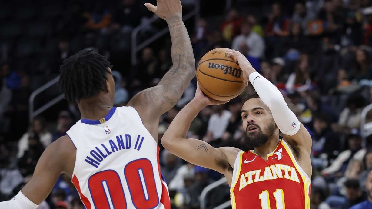 Atlanta Hawks guard Trae Young (11) looks to pass the ball against Detroit Pistons forward Ronald Holland II (00) during the first half of an NBA basketball game Monday, Feb. 3, 2025, in Detroit.