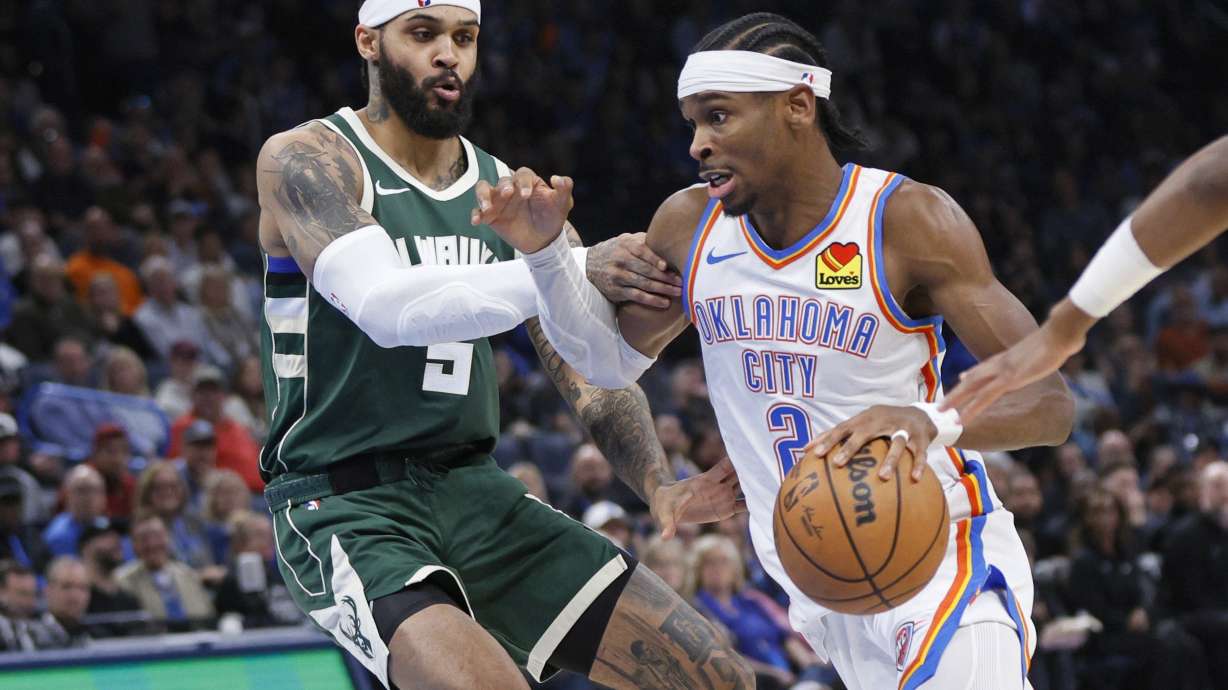 Oklahoma City Thunder guard Shai Gilgeous-Alexander, right, drives against Milwaukee Bucks guard Gary Trent Jr., left, during the second half of an NBA basketball game Monday, Feb. 3, 2025, in Oklahoma City.