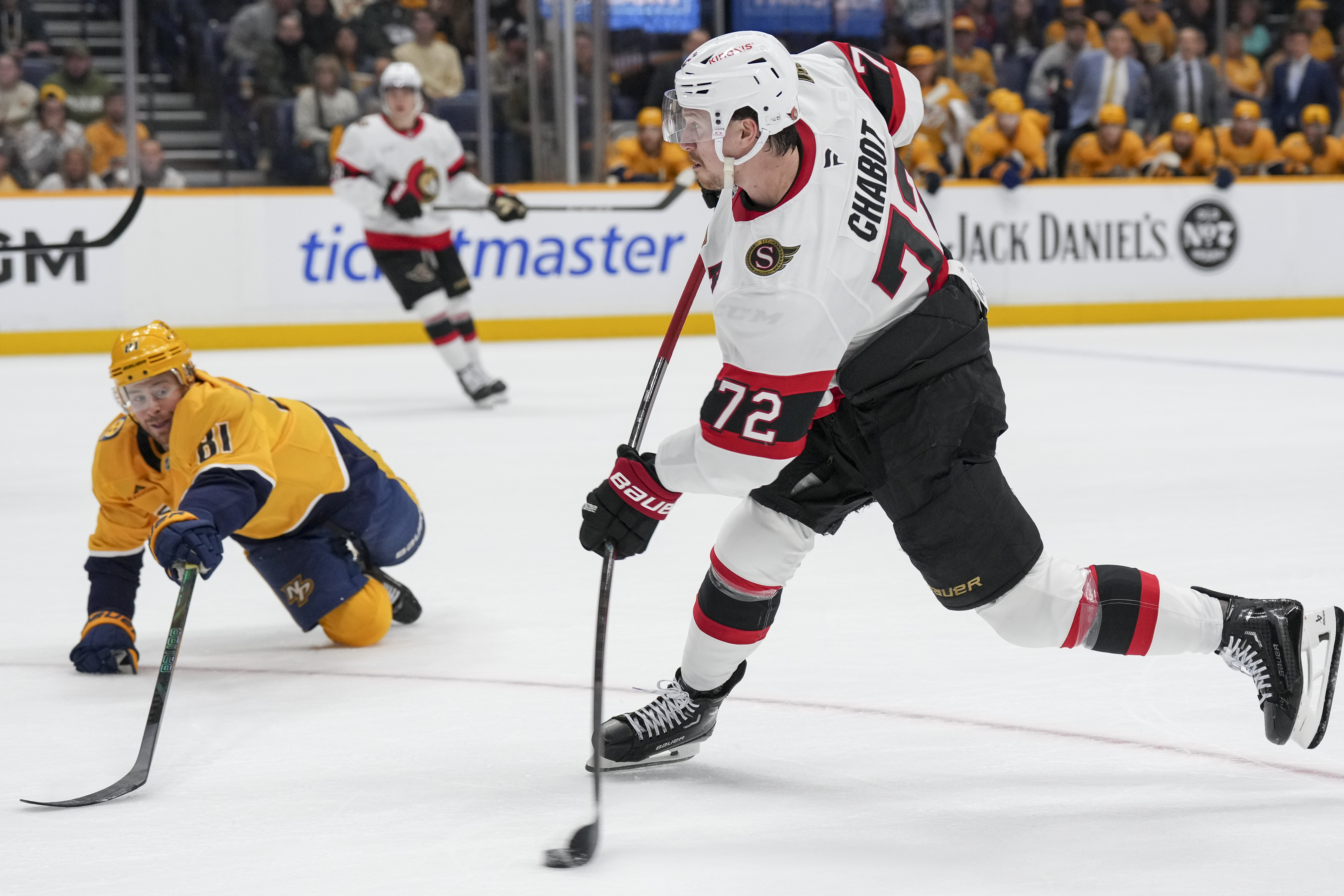 Ottawa Senators defenseman Thomas Chabot (72) shoots the puck past Nashville Predators center Jonathan Marchessault (81) during the first period of an NHL hockey game Monday, Feb. 3, 2025, in Nashville, Tenn.