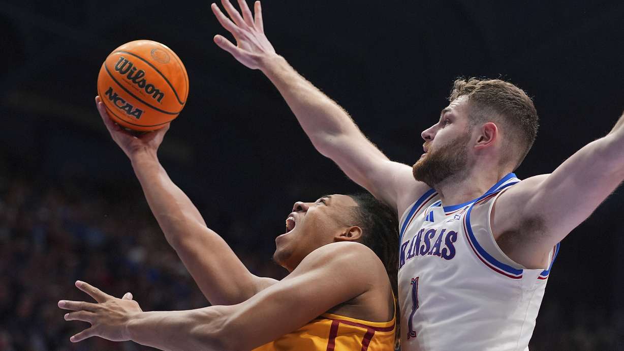 Iowa State center Dishon Jackson, left, shoots under pressure from Kansas center Hunter Dickinson (1) during the second half of an NCAA college basketball game, Monday, Feb. 3, 2025, in Lawrence, Kan.