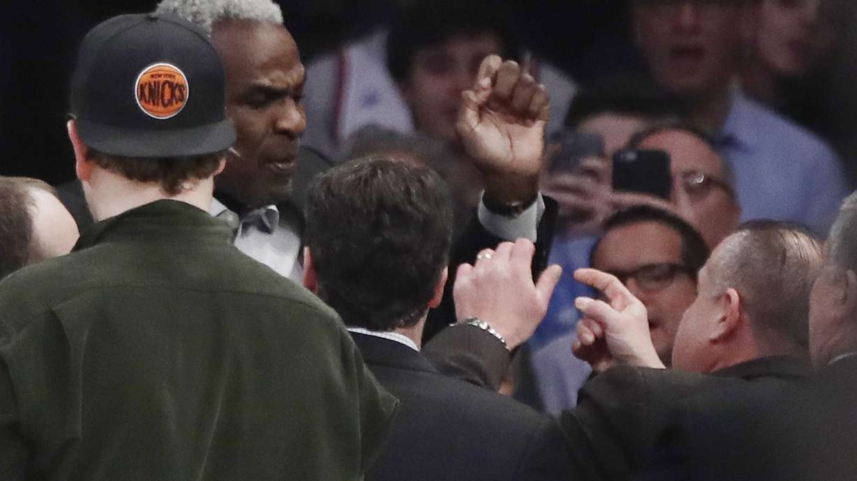FILE - Former New York Knicks player Charles Oakley exchanges words with a security guard during the first half of an NBA basketball game between the New York Knicks and the Los Angeles Clippers, in New York's Madison Square Garden, Feb. 8, 2017.