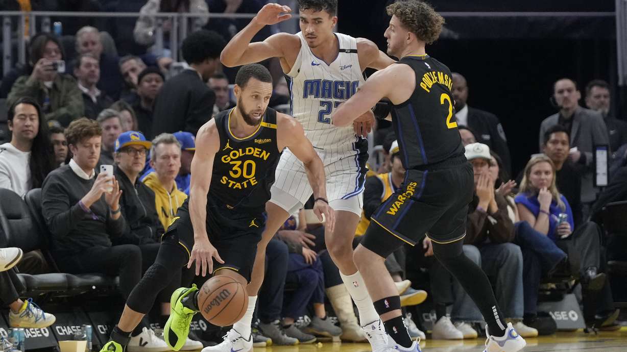 Golden State Warriors guard Stephen Curry (30) drives to the basket as guard Brandin Podziemski (2) screens Orlando Magic forward Tristan da Silva, middle, during the first half of an NBA basketball game in San Francisco, Monday, Feb. 3, 2025.