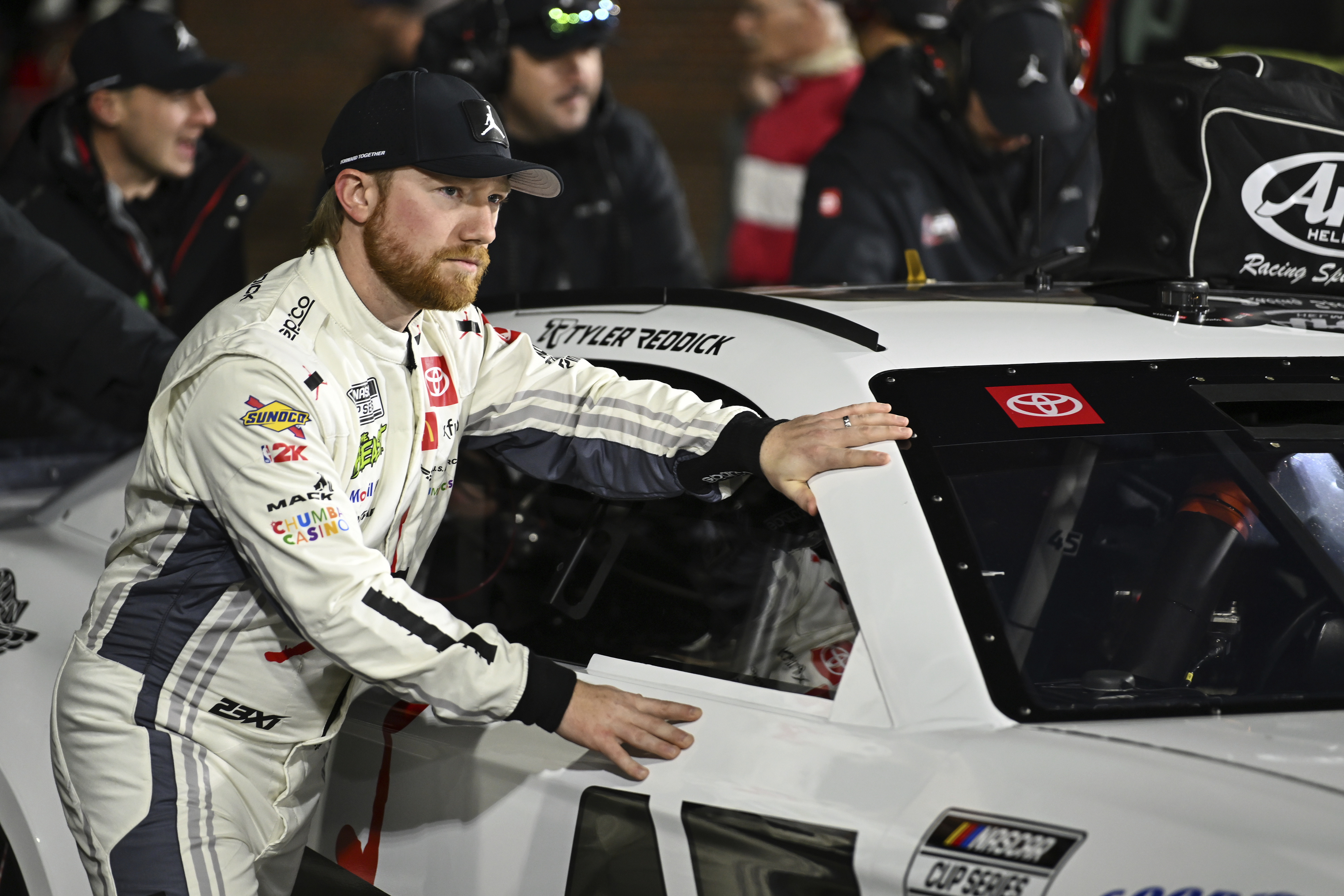 Driver Tyler Reddick pushes his car alongside his pit crew prior to a NASCAR Cup Series auto race at Bowman Gray Stadium, Sunday, Feb. 2, 2025, in Winston-Salem, N.C.
