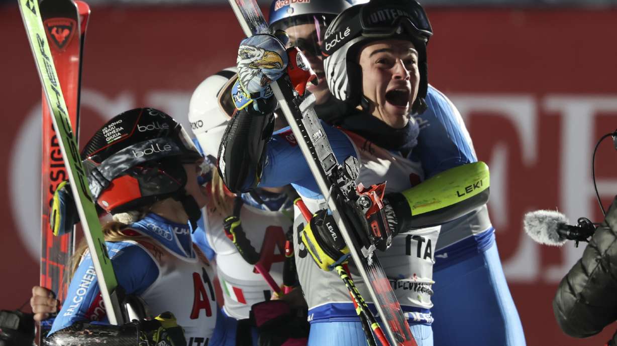 Italy's Filippo Della Vite and Lara Della Mea, left, celebrate winning the gold medal of the alpine ski, World Championship team parallel event, in Saalbach-Hinterglemm, Austria, Tuesday, Feb. 4, 2025.
