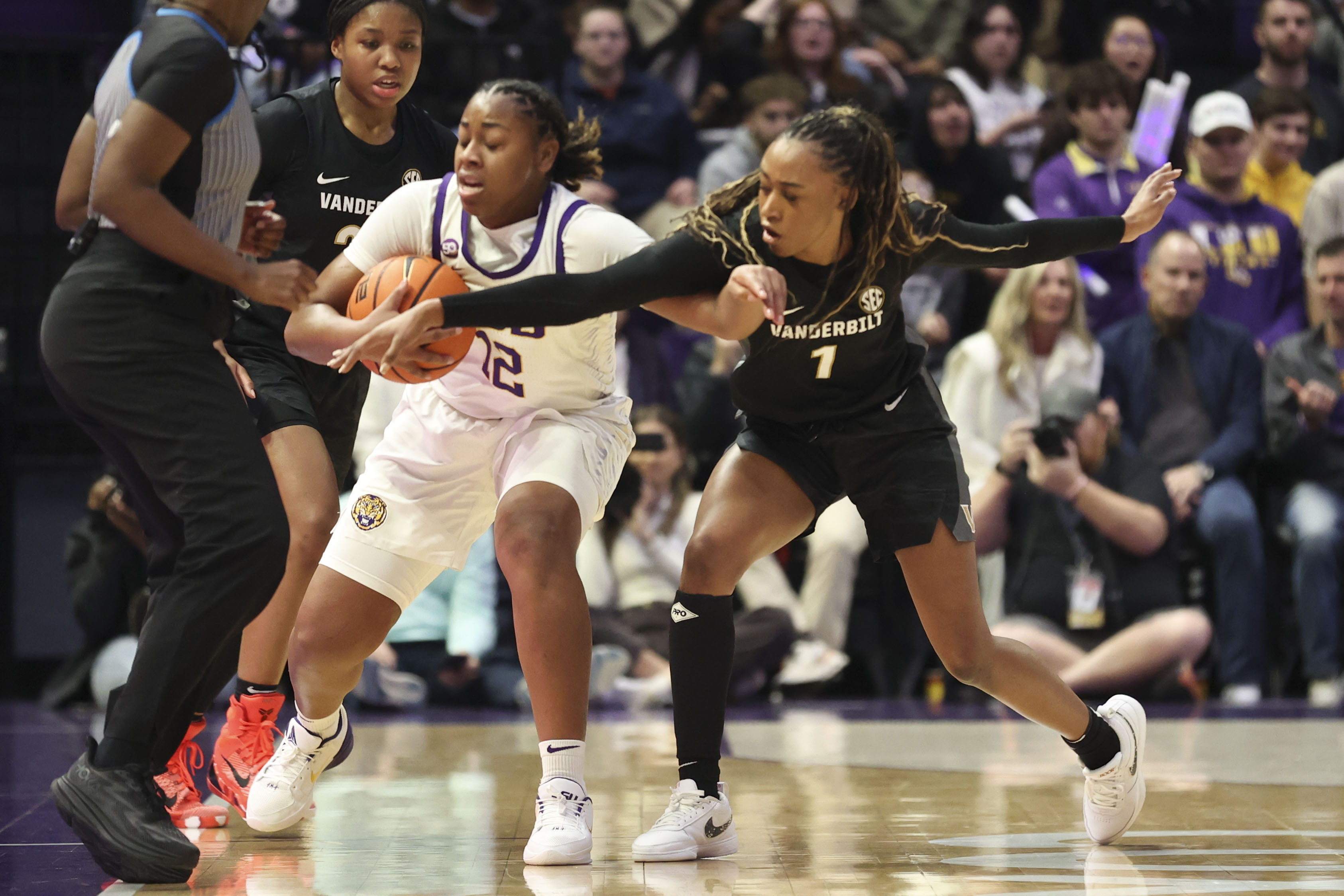 Vanderbilt guard Mikayla Blakes (1) tries to steal the ball from LSU guard Mikaylah Williams (12) during the first half of an NCAA college basketball game in Baton Rouge, La., Monday, Jan. 13, 2025. 