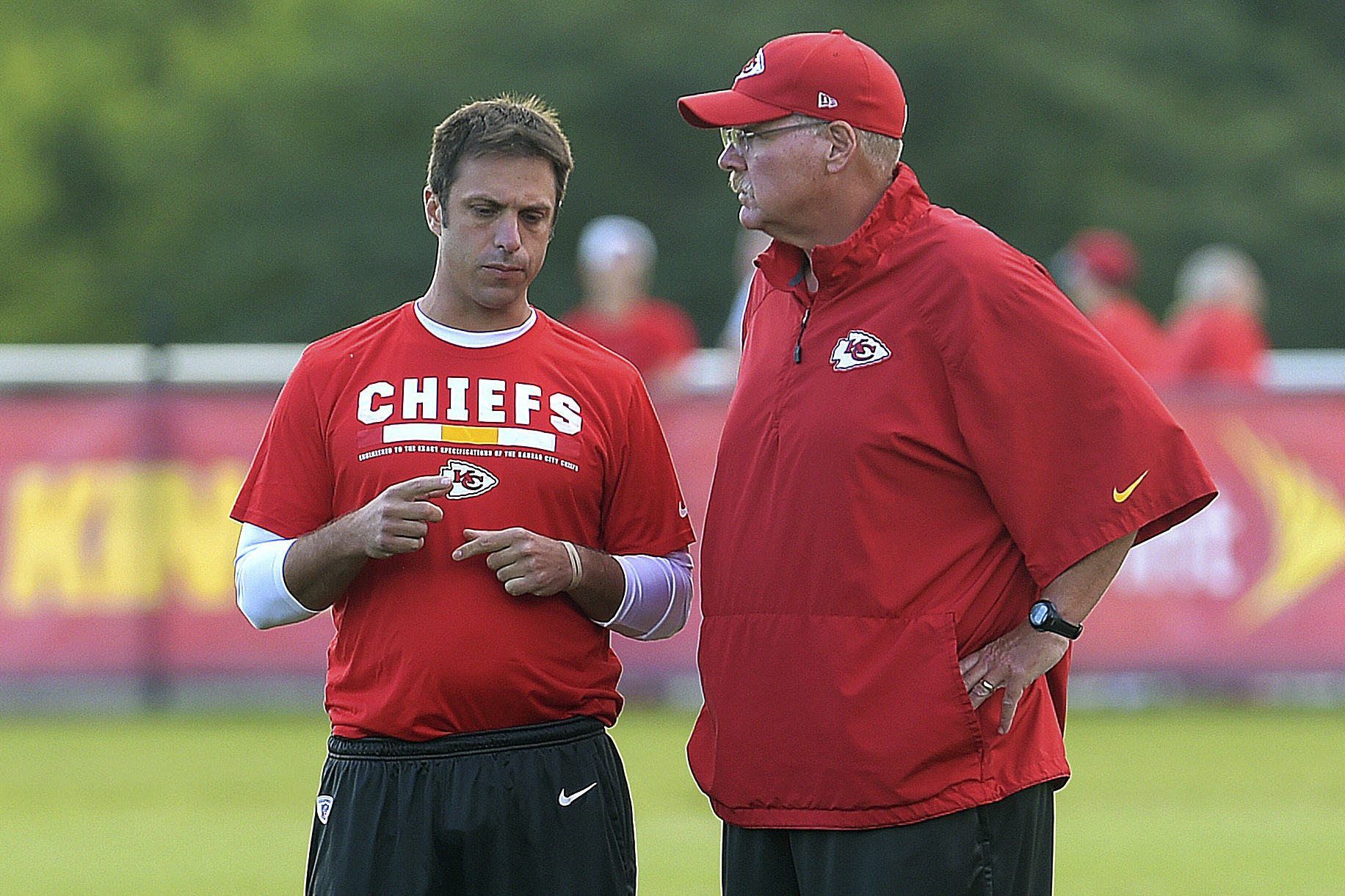 FILE - Kansas City Chiefs general manager Brett Veach talks with coach Andy Reid during NFL football training camp Thursday, Aug 3, 2017, in St. Joseph, Mo. 