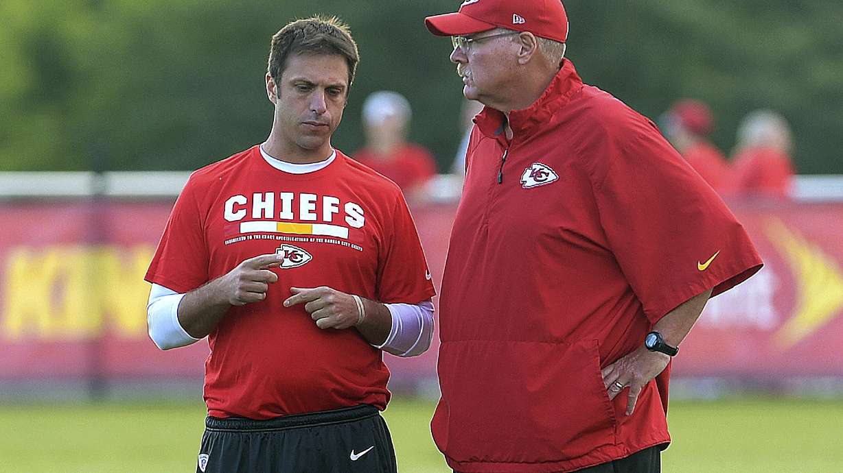 FILE - Kansas City Chiefs general manager Brett Veach talks with coach Andy Reid during NFL football training camp Thursday, Aug 3, 2017, in St. Joseph, Mo.