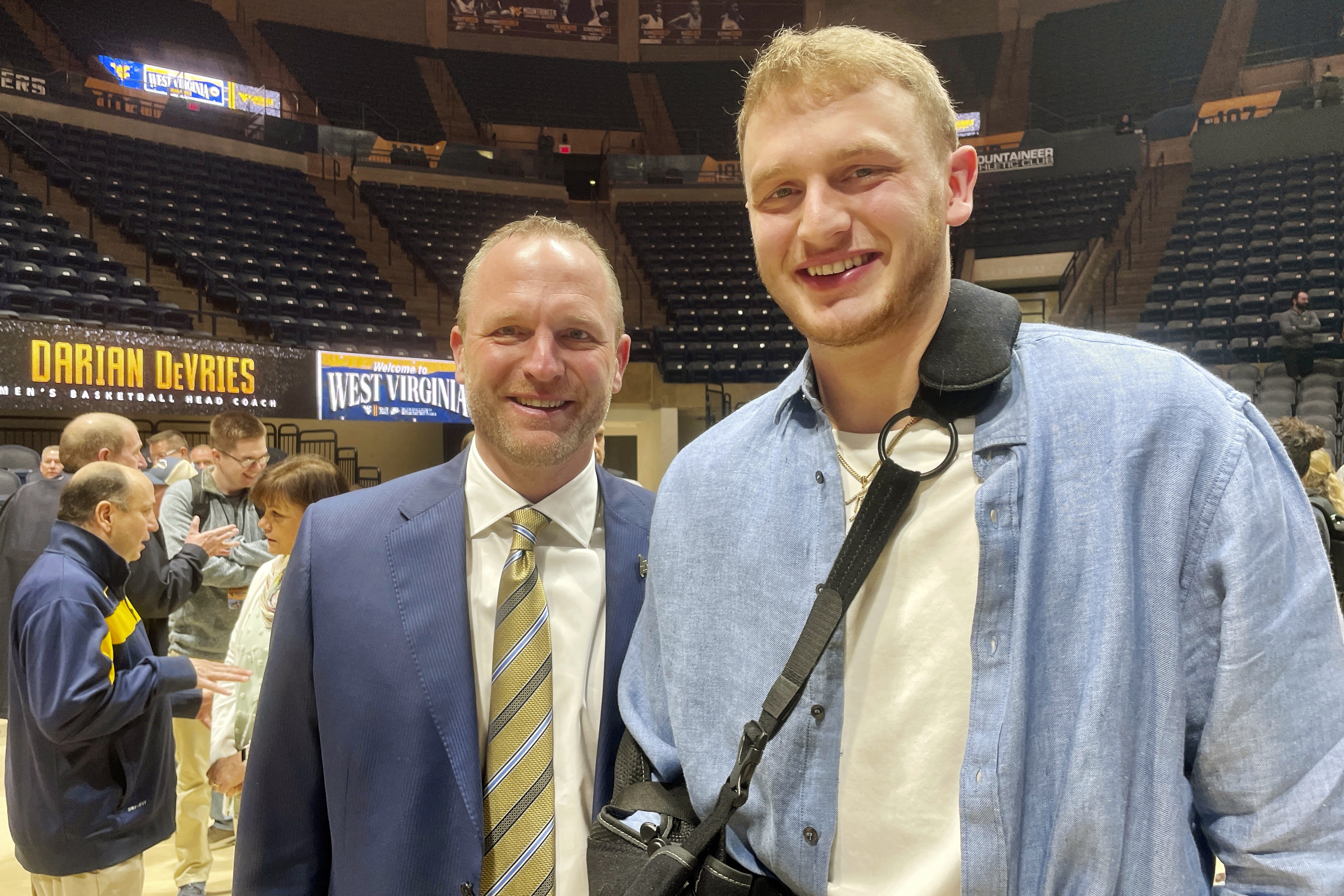 FILE - West Virginia men's NCAA college basketball coach Darian DeVries poses with his son, Tucker, after an introductory news conference Thursday, March 28, 2024, in Morgantown, W.Va. 