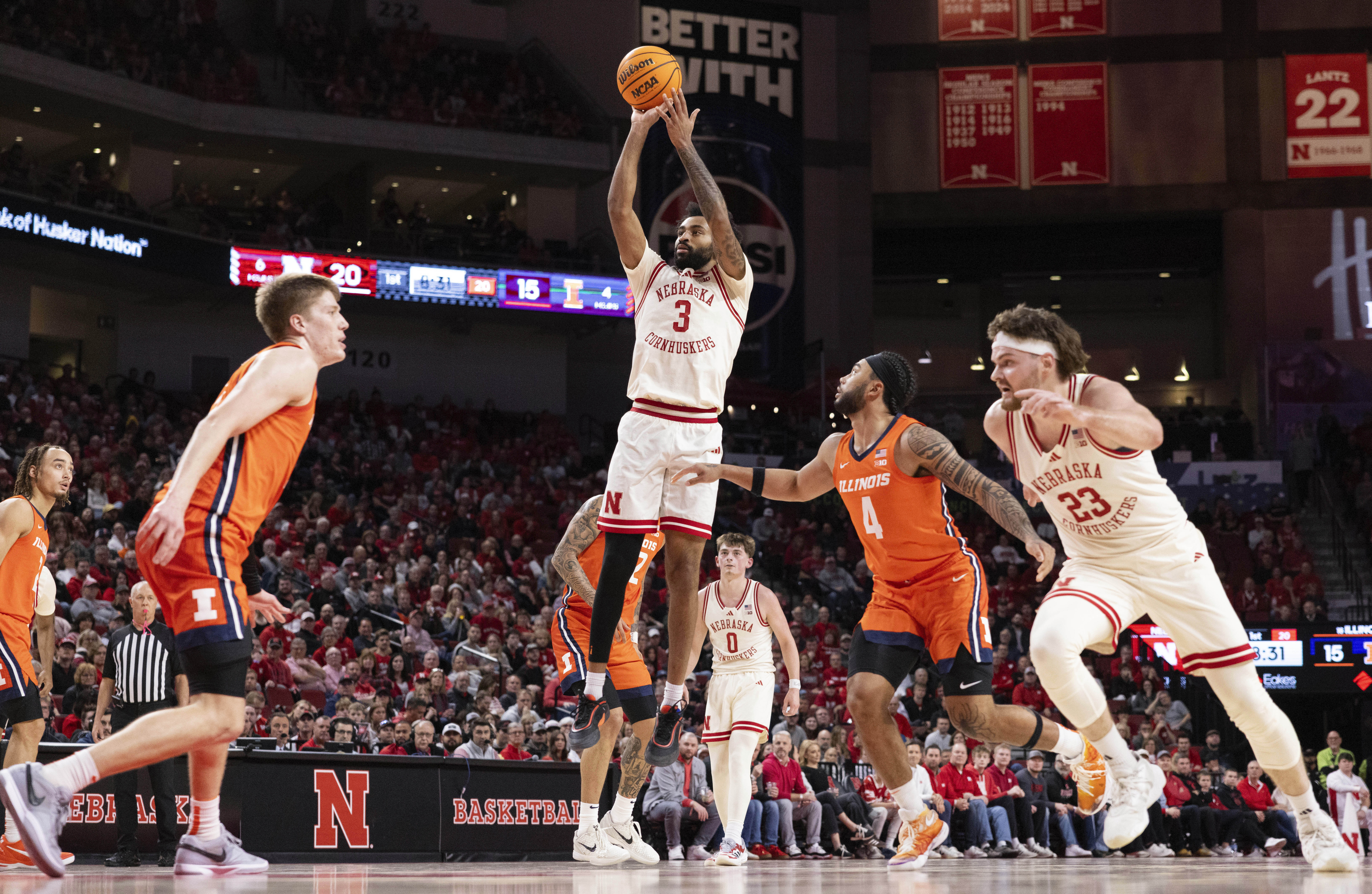 Nebraska's Brice Williams, center, shoots against Illinois' Ben Humrichous, front left, and Kylan Boswell, second from right, during the first half of an NCAA college basketball game Thursday, Jan. 30, 2025, in Lincoln, Neb. 