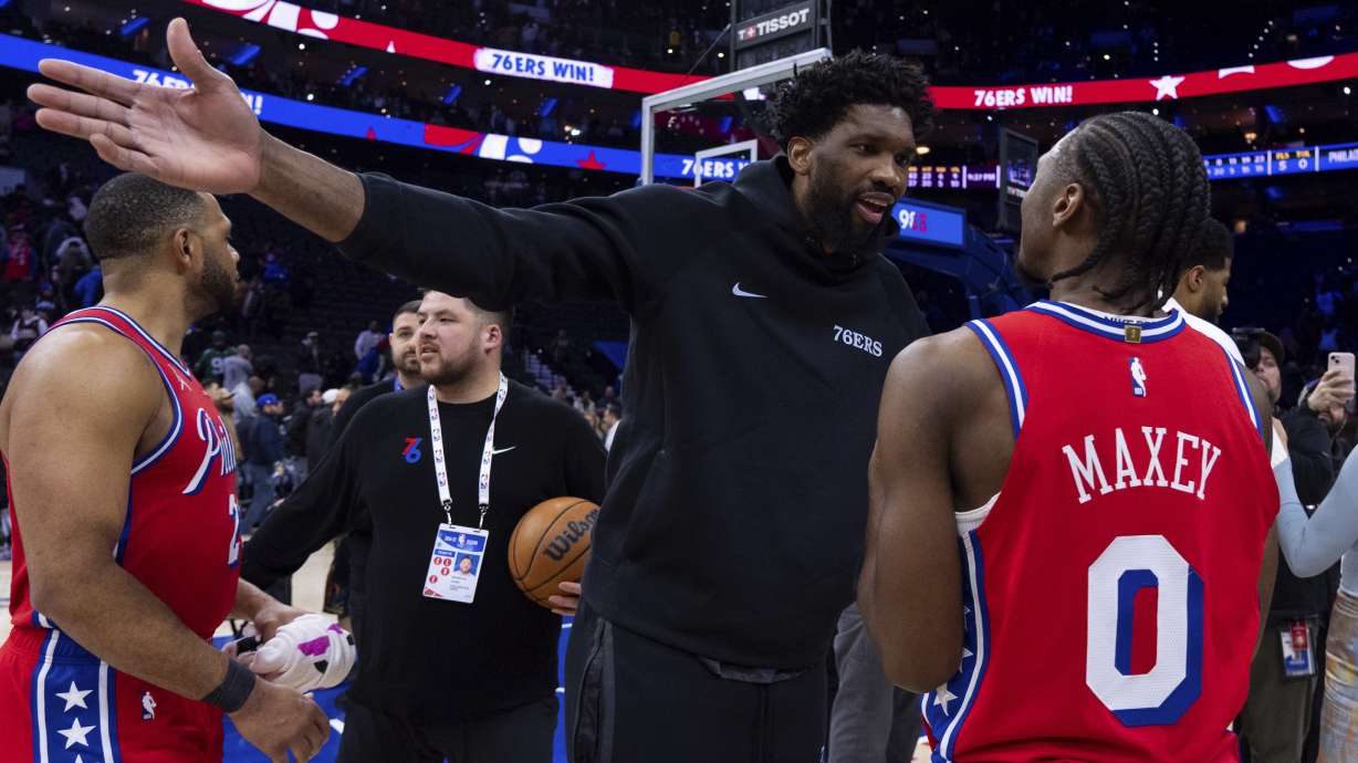 Philadelphia 76ers' Joel Embiid, center right, talks with teammate Tyrese Maxey (0) following an NBA basketball game against the Cleveland Cavaliers, Friday, Jan. 24, 2025, in Philadelphia.