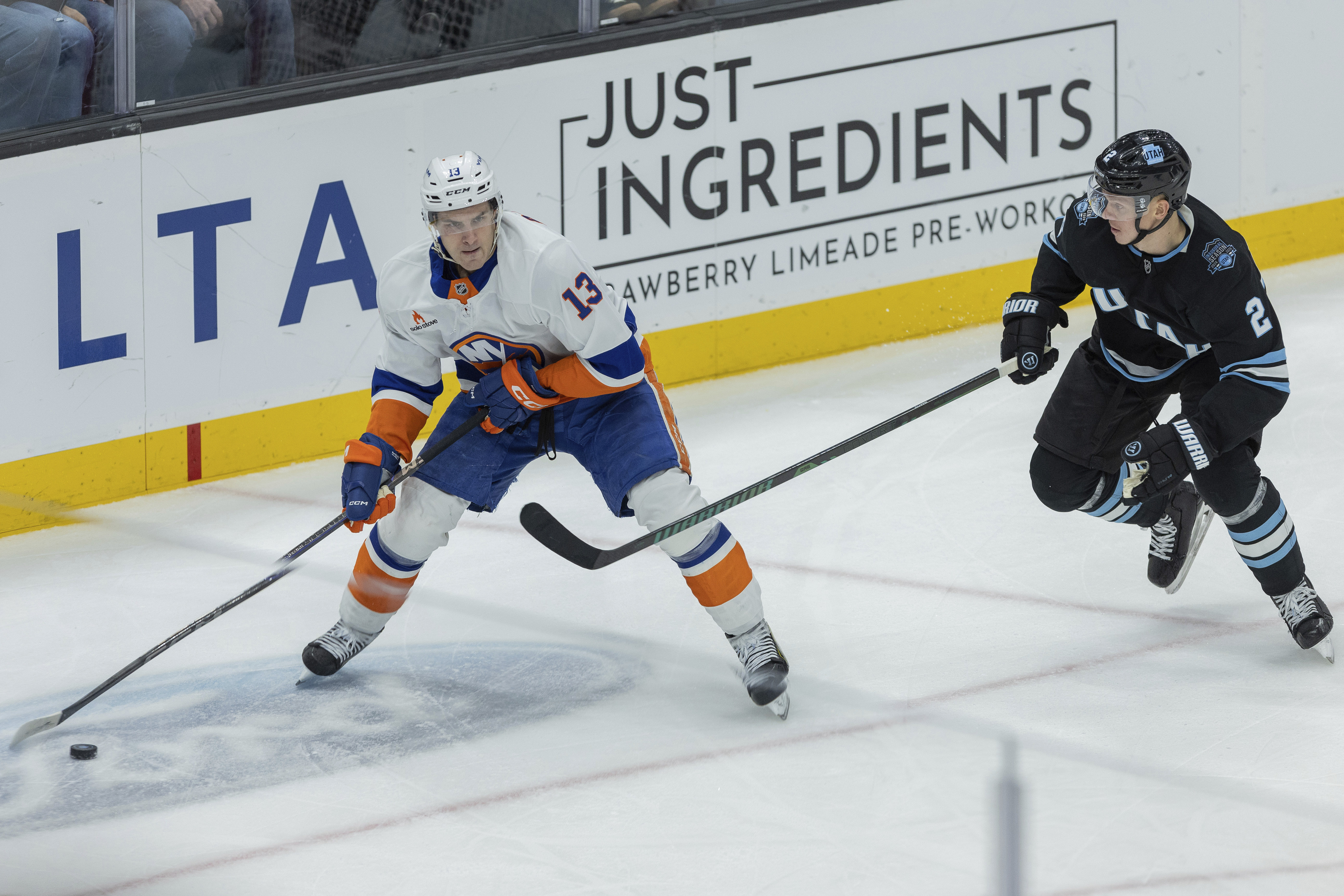 New York Islanders center Mathew Barzal (13) moves the puck against Utah Hockey Club defenseman Olli Maatta (2) during the third period of an NHL hockey game Saturday, Jan. 11, 2025, in Salt Lake City. 