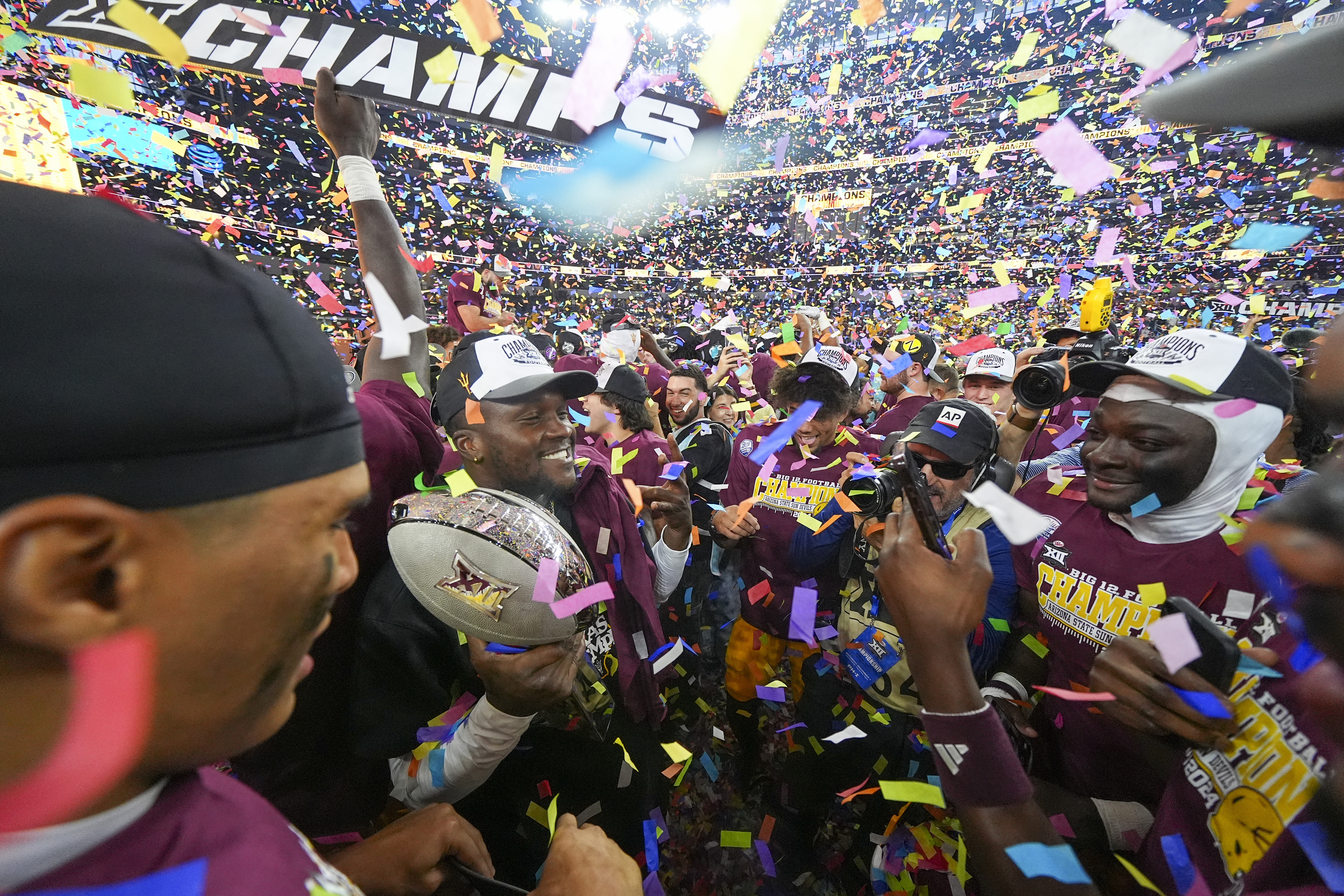FILE - Arizona State players celebrate following the Big 12 Conference championship NCAA college football game against Iowa State, in Arlington, Texas, Dec. 7, 2024. 