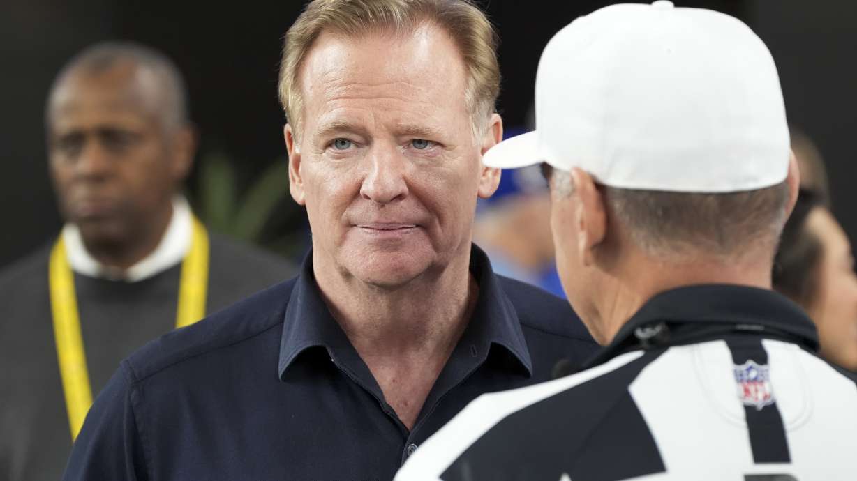 NFL Commissioner Roger Goodell, left, talks with Referee John Hussey before an NFL wild card playoff football game between the Los Angeles Rams and Minnesota Vikings, Monday, Jan. 13, 2025, in Glendale, Ariz.