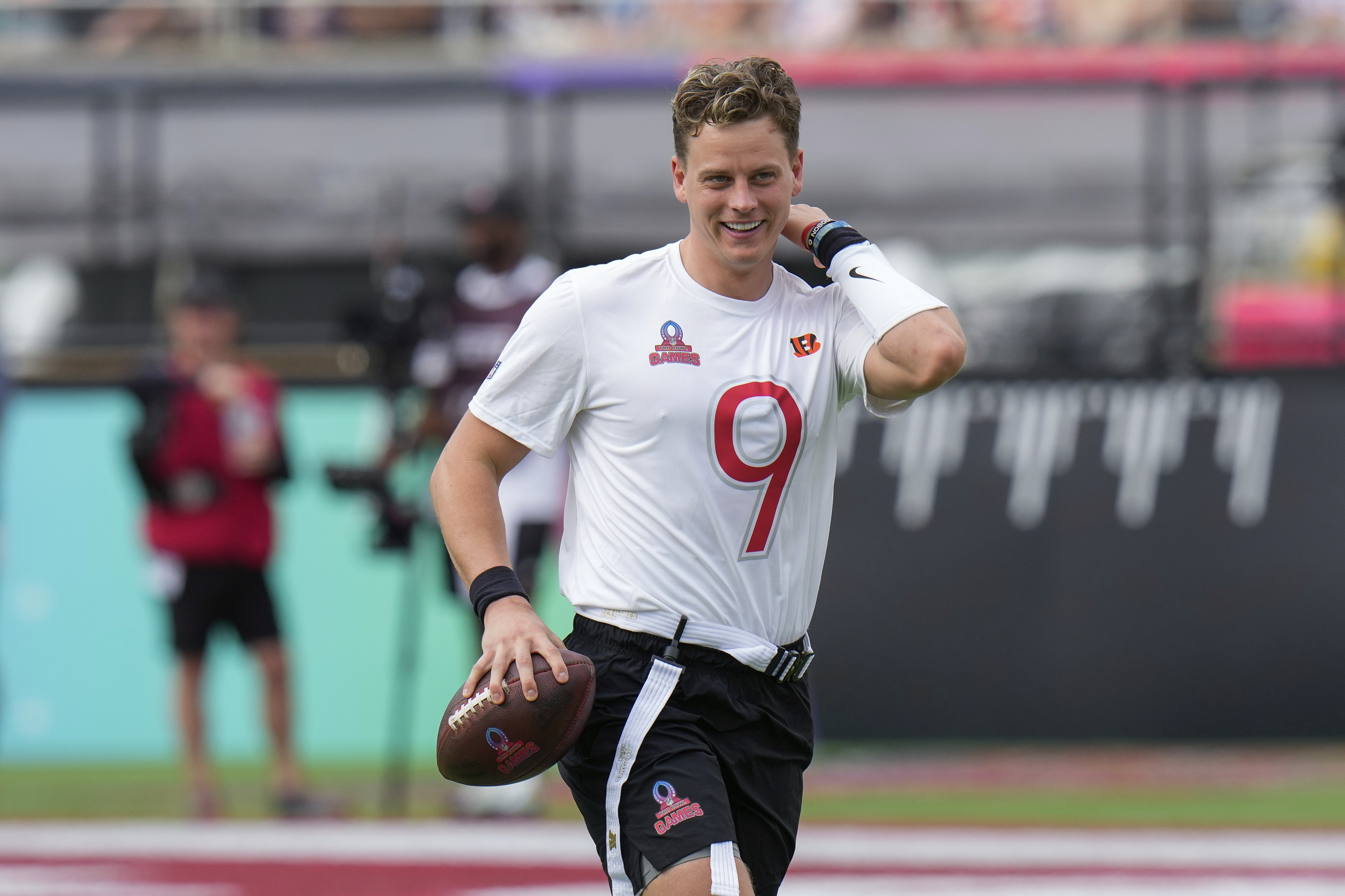 FILE - AFC quarterback Joe Burrow, of the Cincinnati Bengals, smiles after he was sacked during the flag football event at the NFL Pro Bowl, in Orlando, Feb. 2, 2025. 