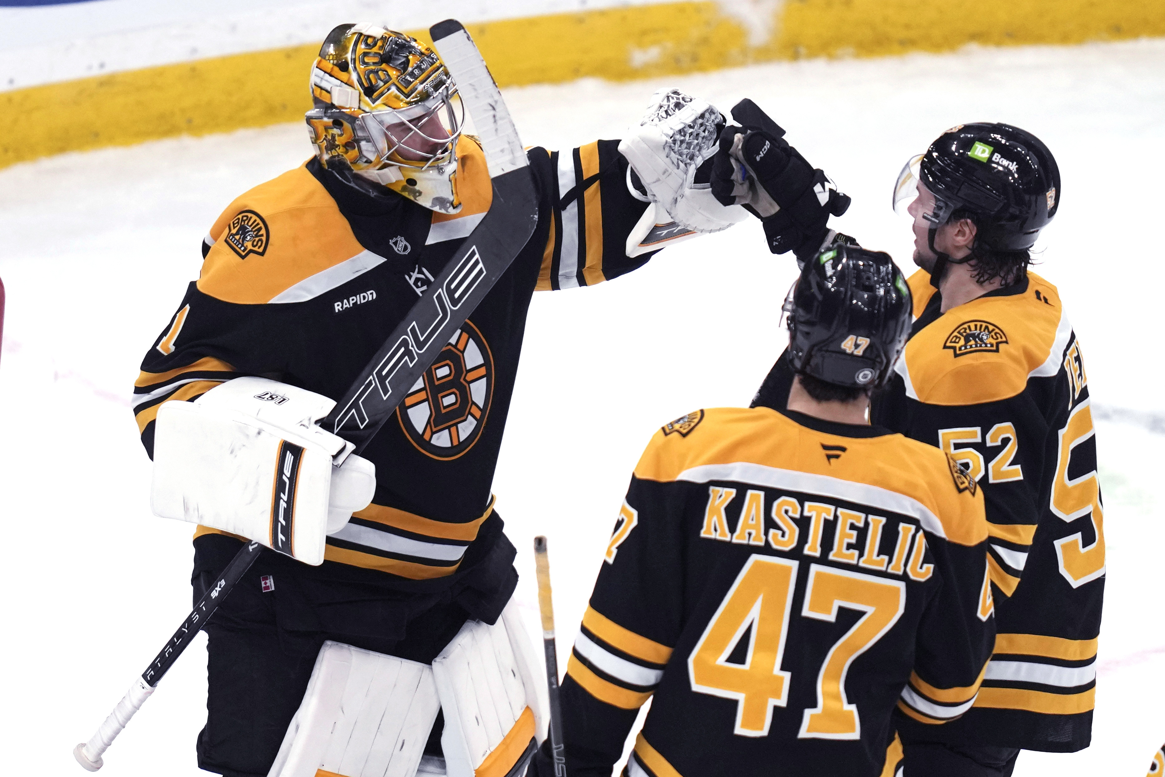 Boston Bruins goaltender Jeremy Swayman, left, is congratulated after shutting out the Minnesota Wild 3-0 after an NHL hockey game, Tuesday, Feb. 4, 2025, in Boston.