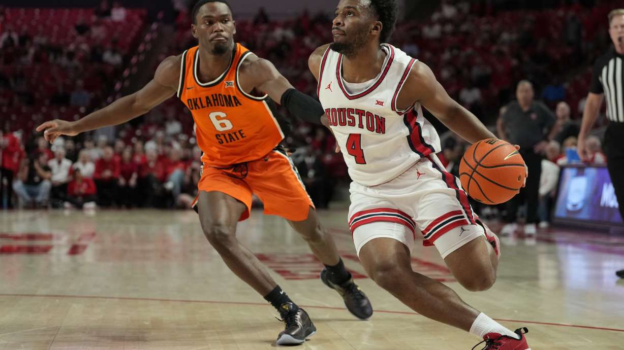 Houston guard L.J. Cryer (4) drives around Oklahoma State guard Brandon Newman (6) during the first half of an NCAA college basketball game Tuesday, Feb. 4, 2025, in Houston.