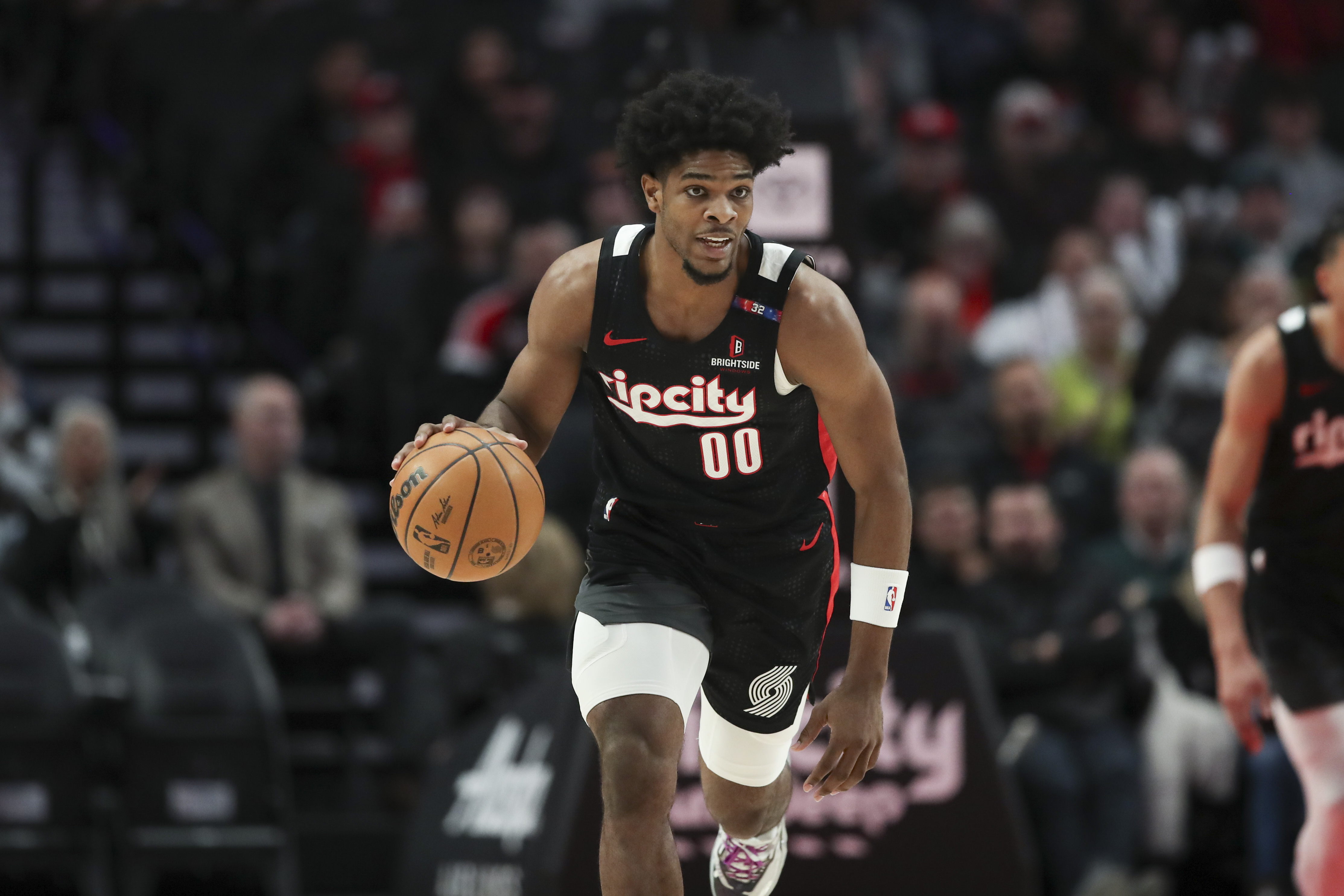 Portland Trail Blazers guard Scoot Henderson (00) brings the ball up court against the Indiana Pacers during the first half of an NBA basketball game Tuesday, Feb. 4, 2025, in Portland, Ore.